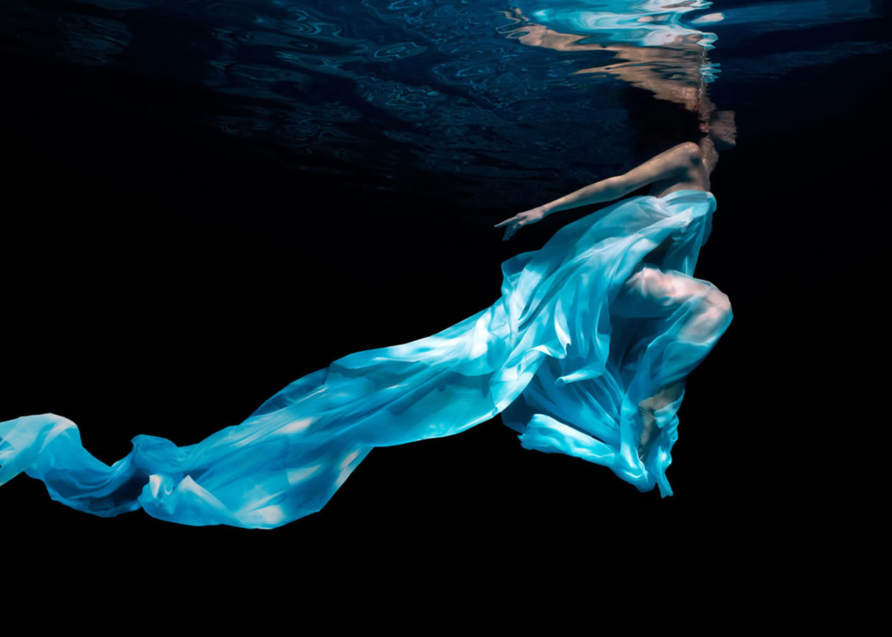 woman underwater, turquoise dress, photo by Patrick Curtet