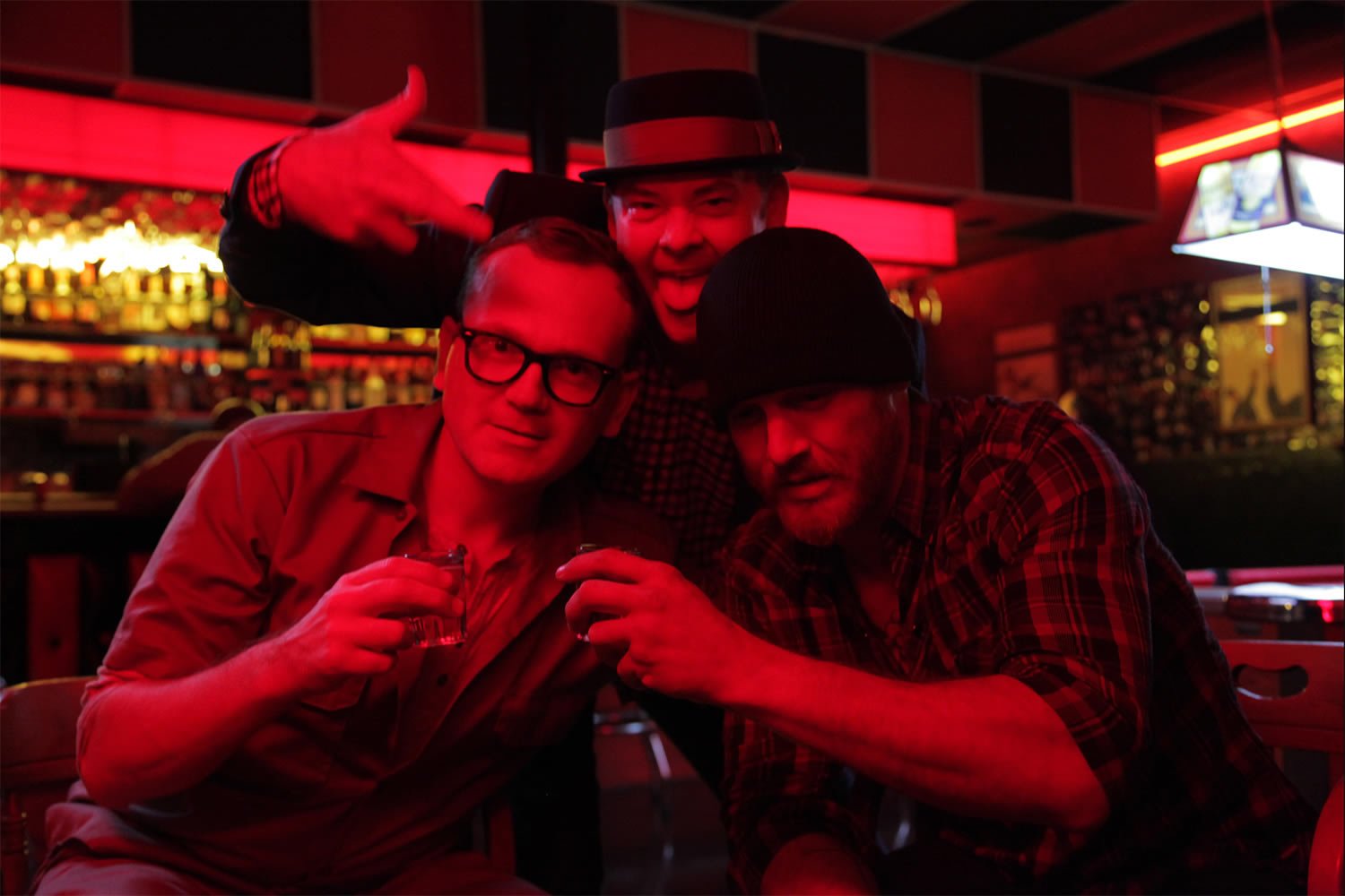 three guys at a bar, with red light, cheap thrills