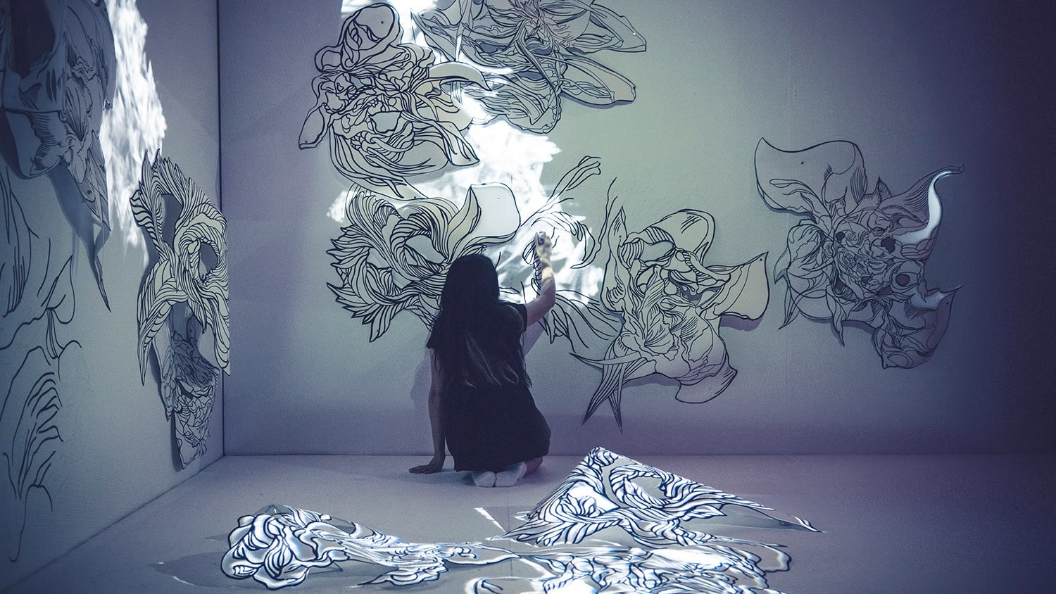 artist Sougwen Chung drawing on a wall