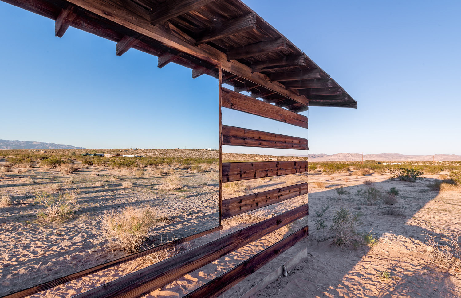 side view of mirror house in desert by philip k smith