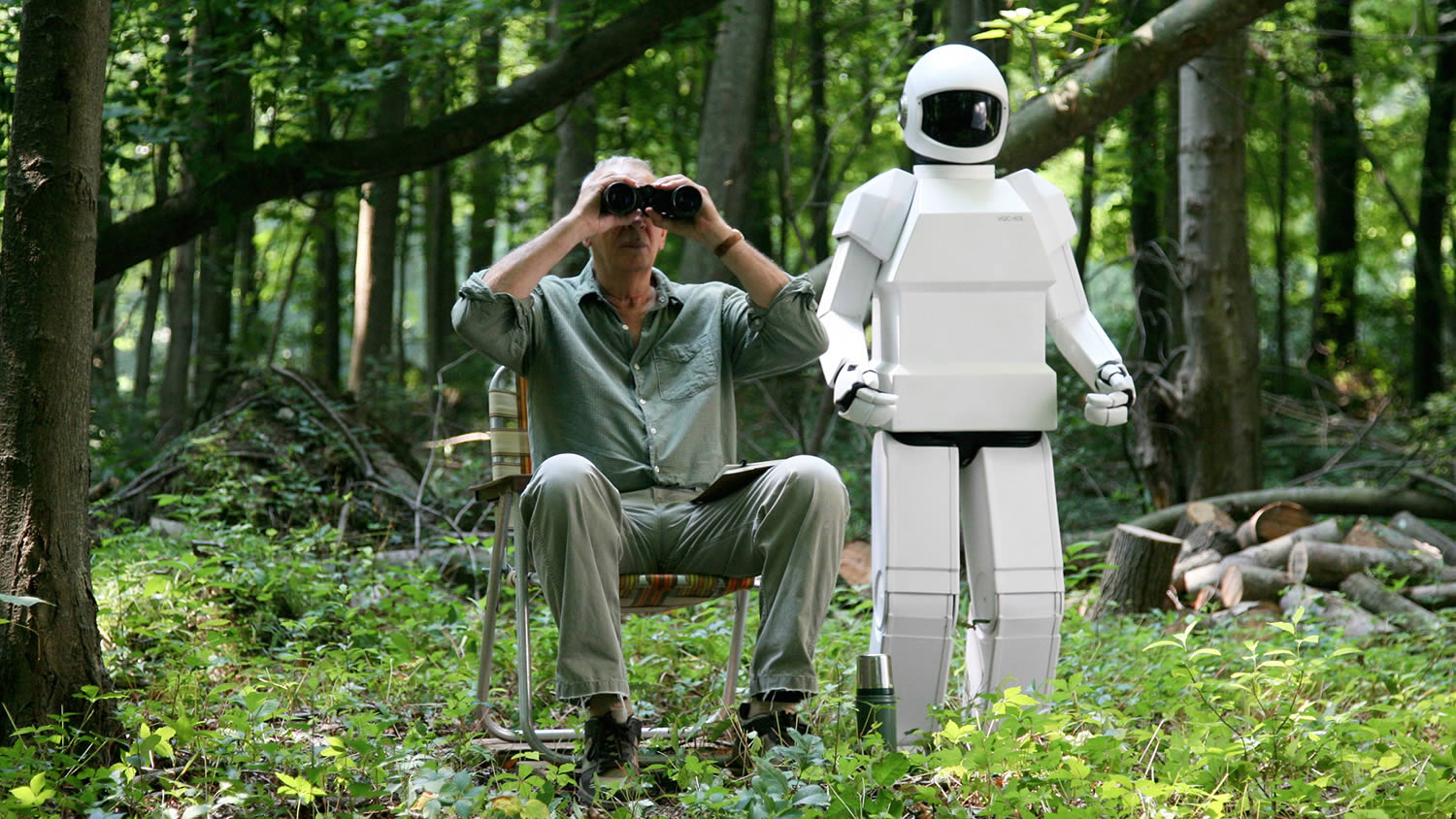 robot & frank, man sitting in chair with binoculars and robot at side