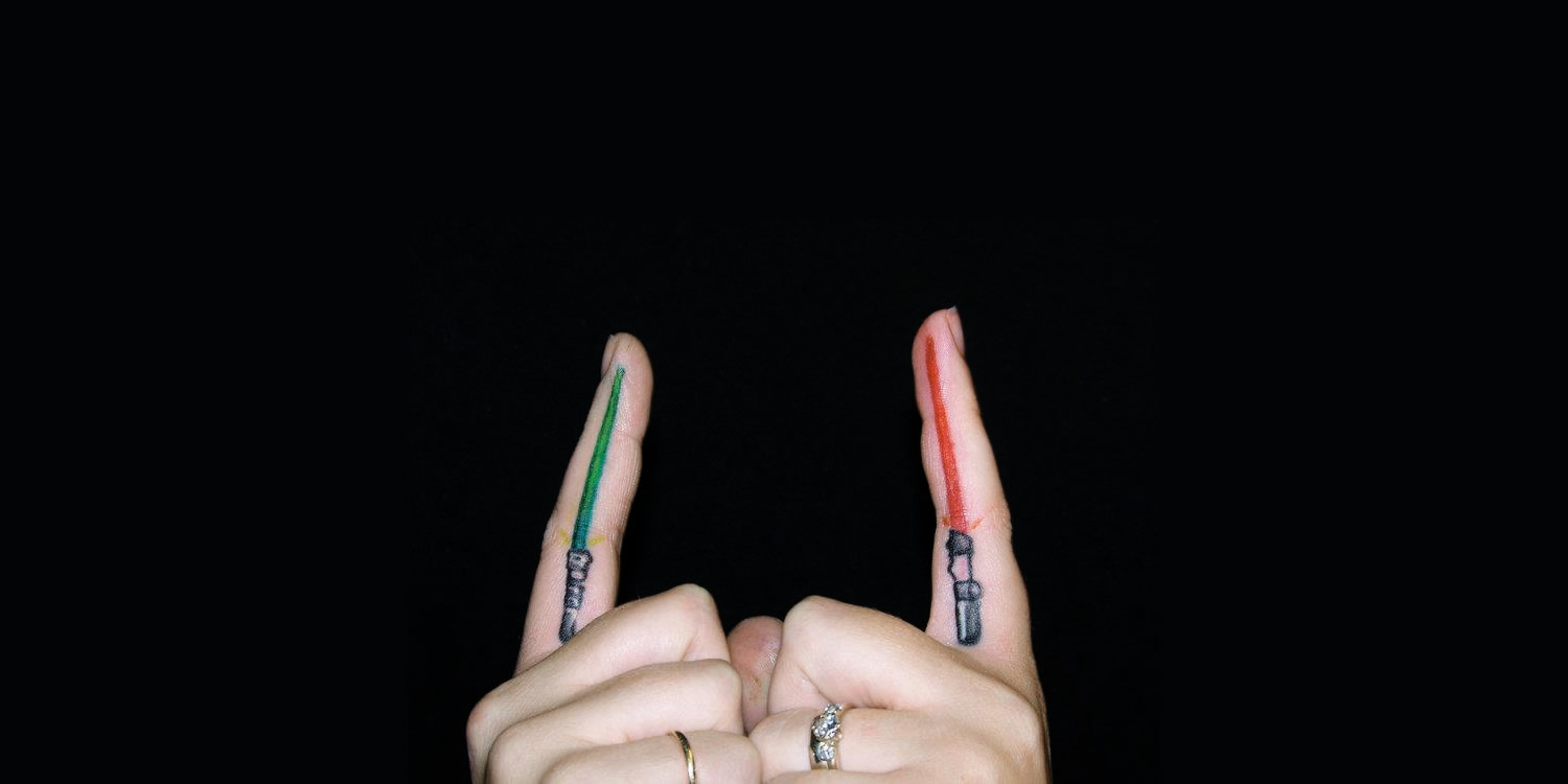 green and red lightsaber tattoos on fingers by Travis Boudreau, star wars