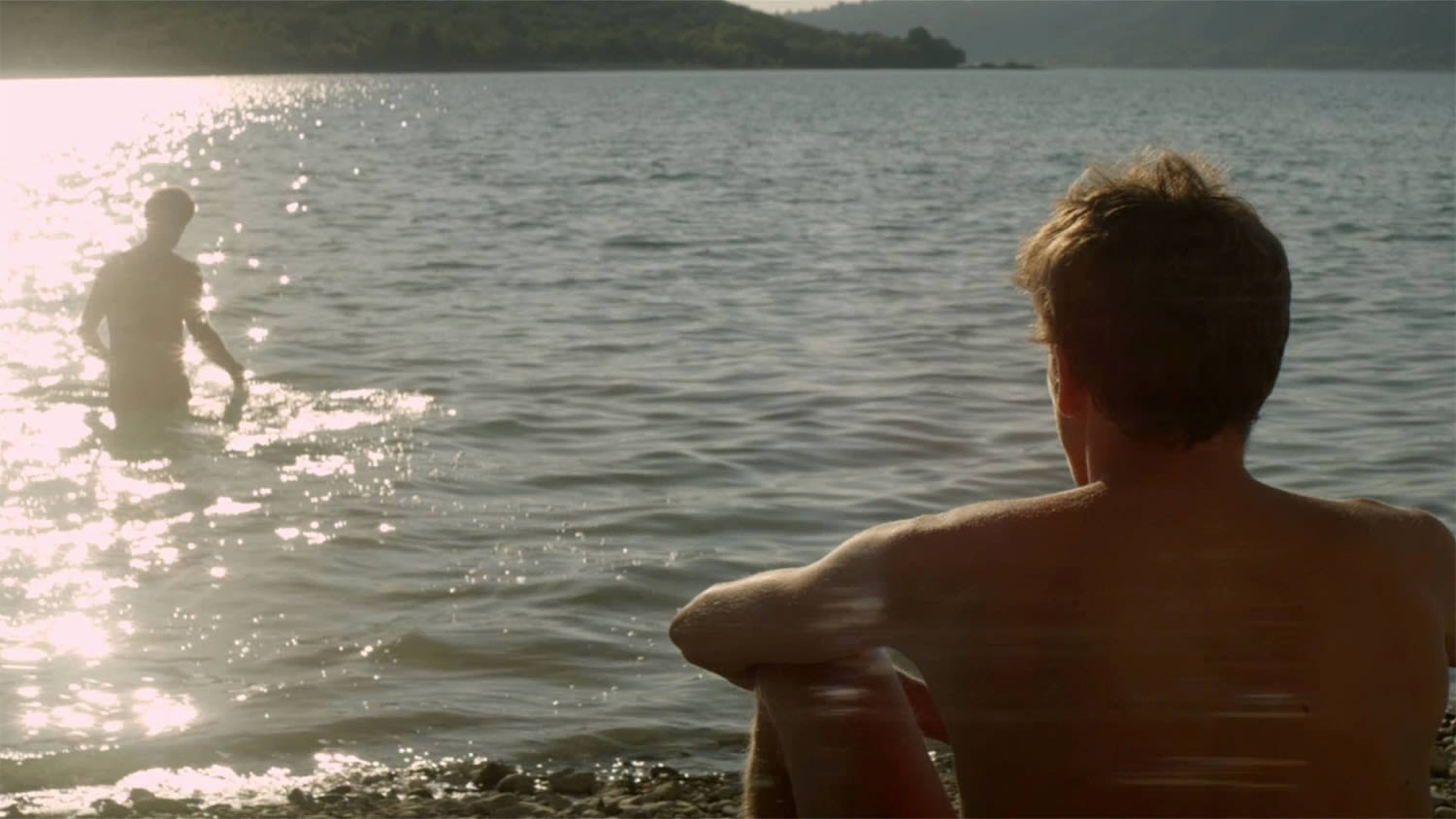  Franck sitting on the beach waiting for her lover, stranger by the lake