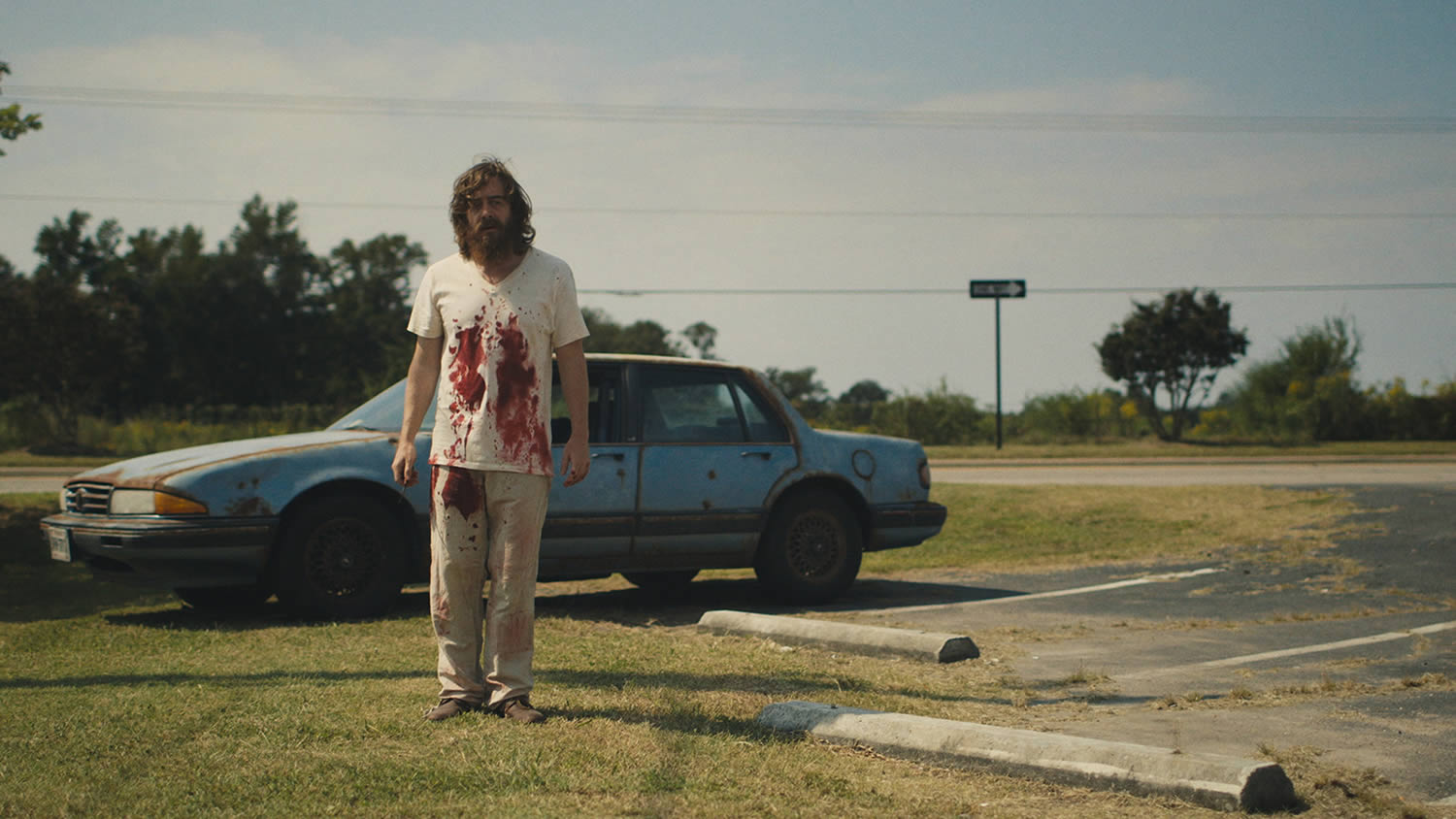 blue ruin actor with blood on shirt