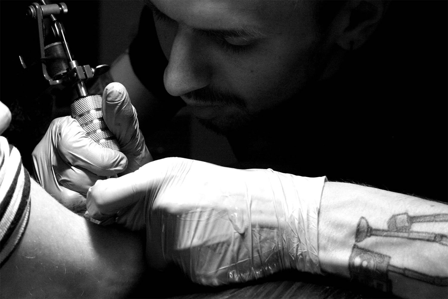 artist brezinski working on a tattoo