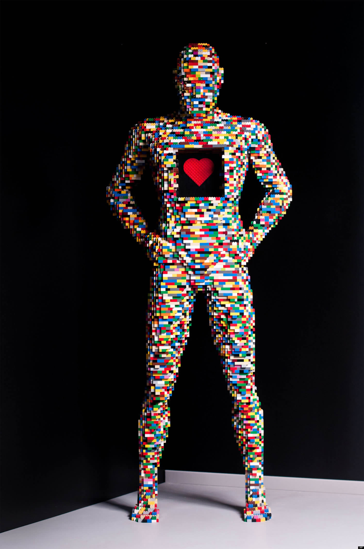 multicolored lego man with heart, by nathan sawaya