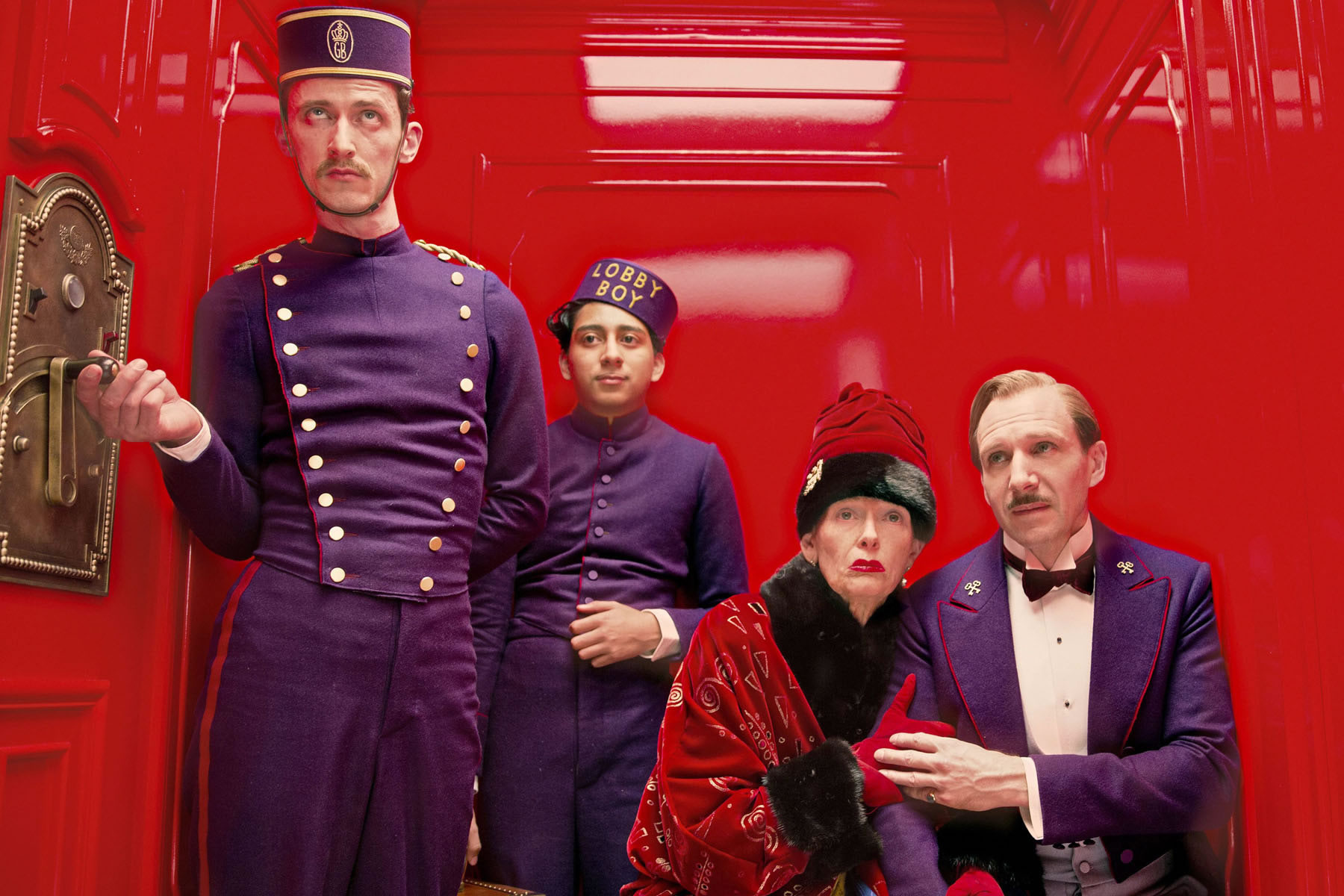 bellboy and passengers in elevator, in The Grand Budapest Hotel