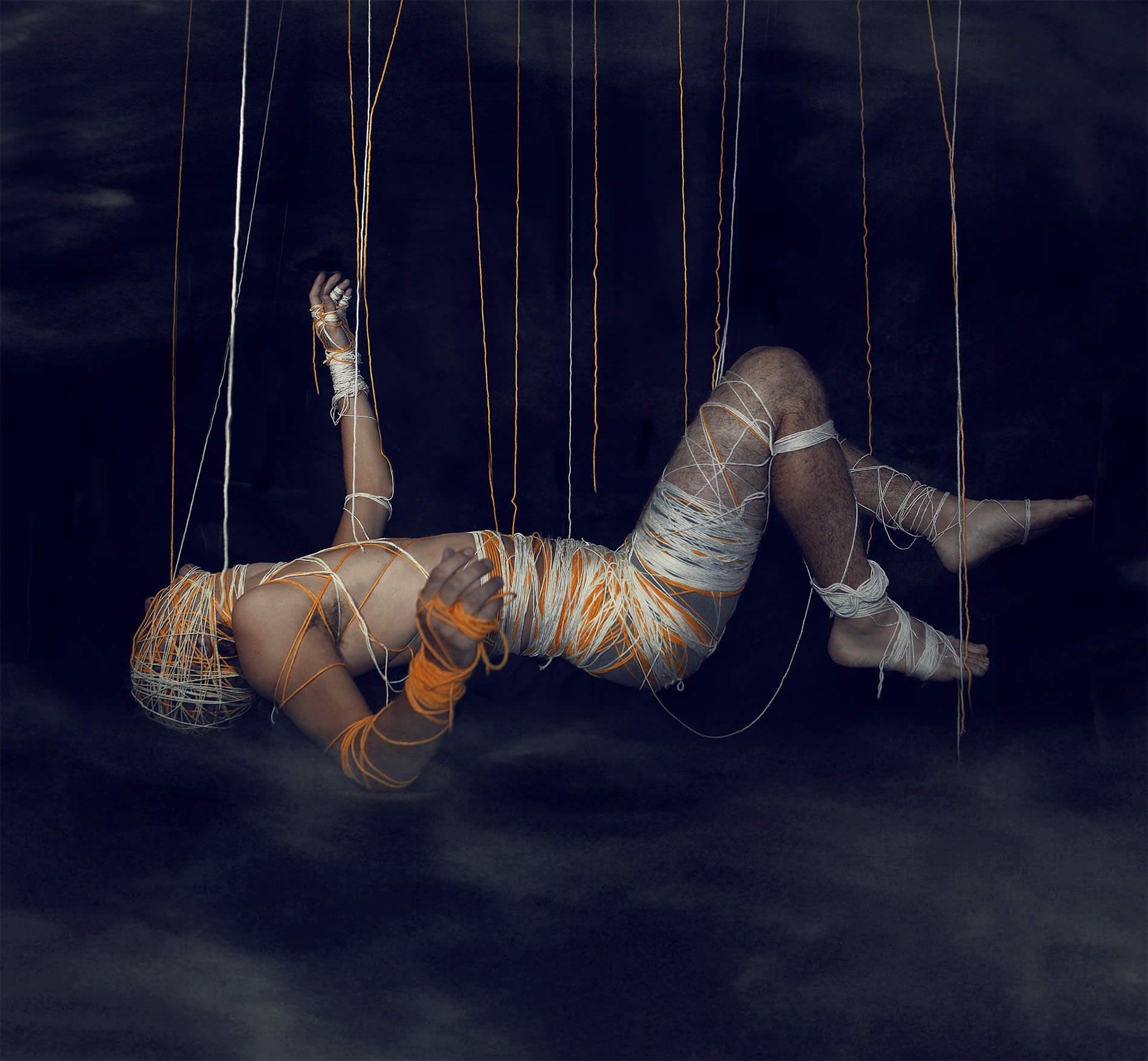 man hanging by strings, photo by kavan cardoza 