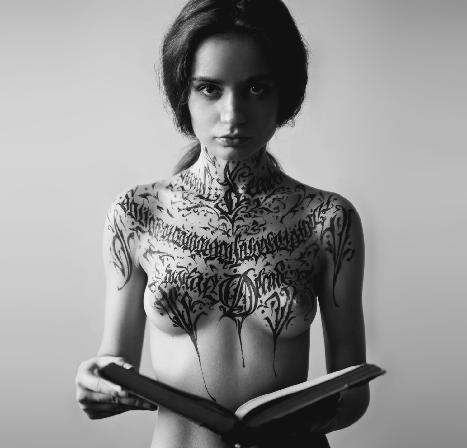 black and white picture of female holding a book