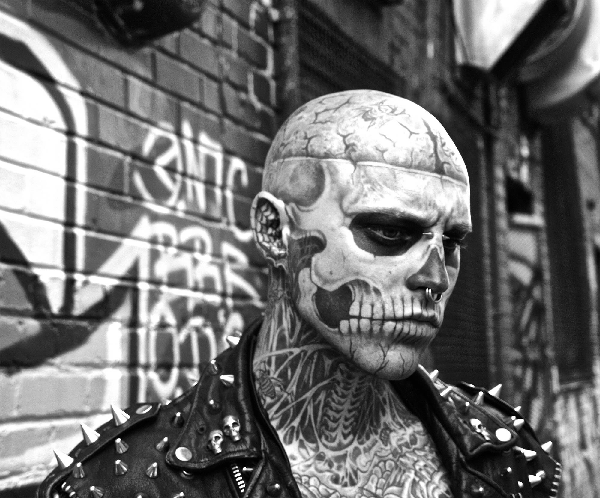 rico the zombie (rick genest) in front of graffiti wall