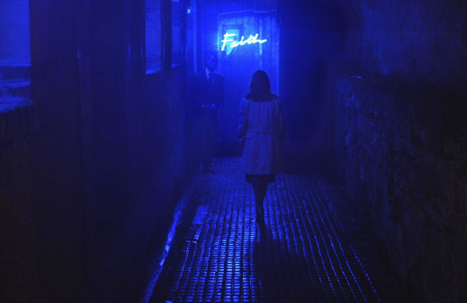 woman walking down alley, blut lighting. Alleluia movie