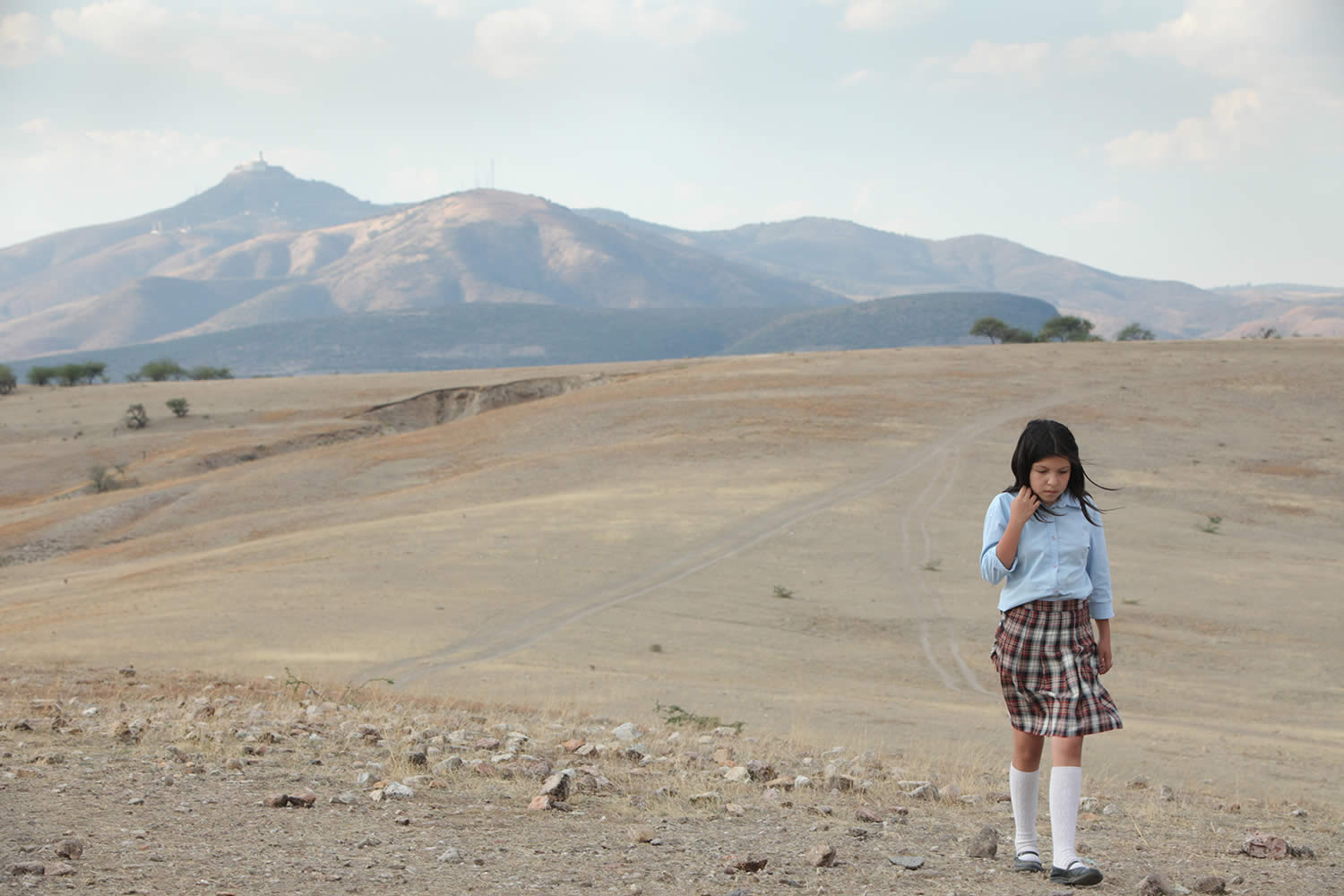 girl walking on dusty field, heli  movie