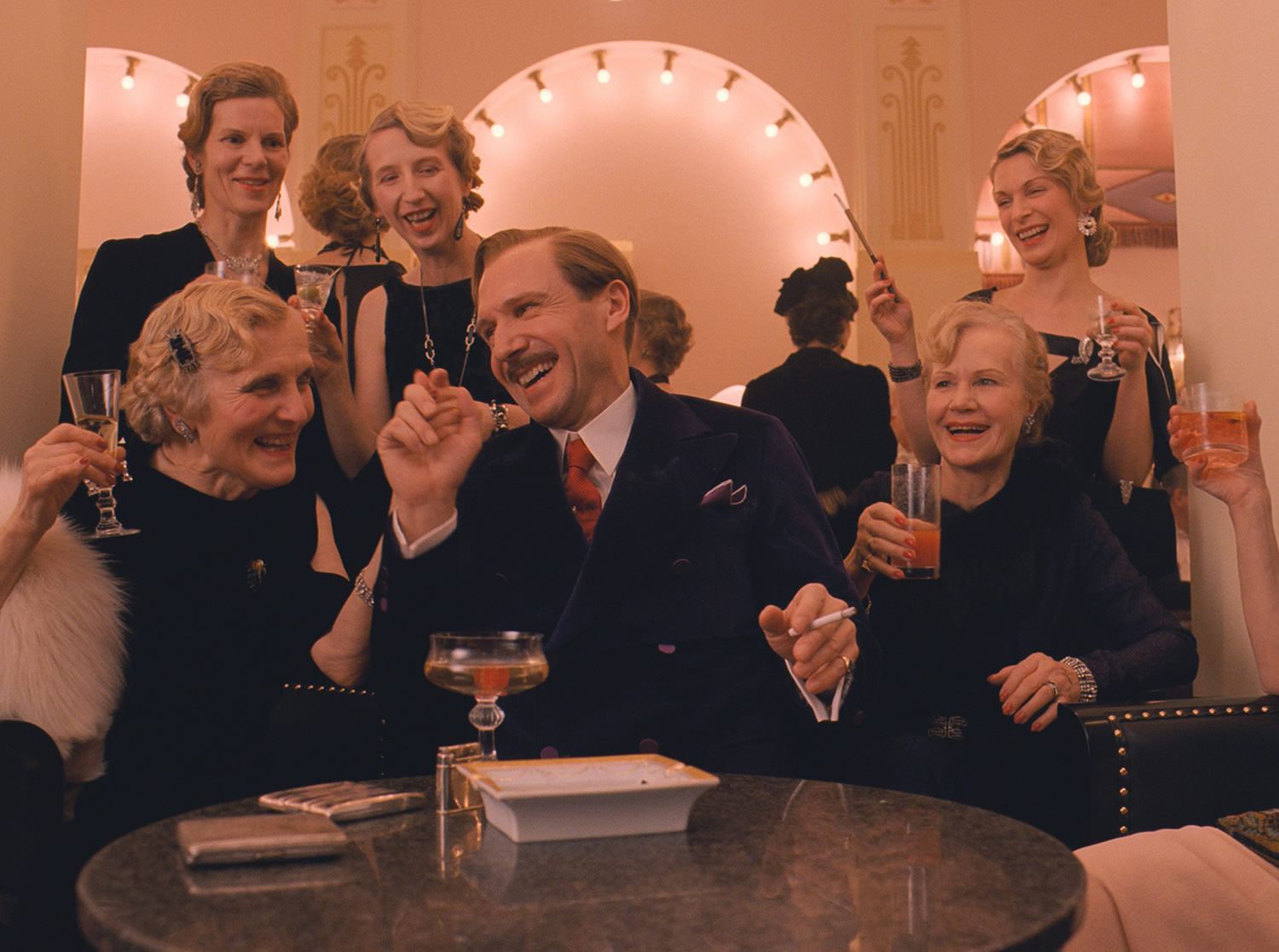 m gustave speaking with the ladies in the grand budapest hotel