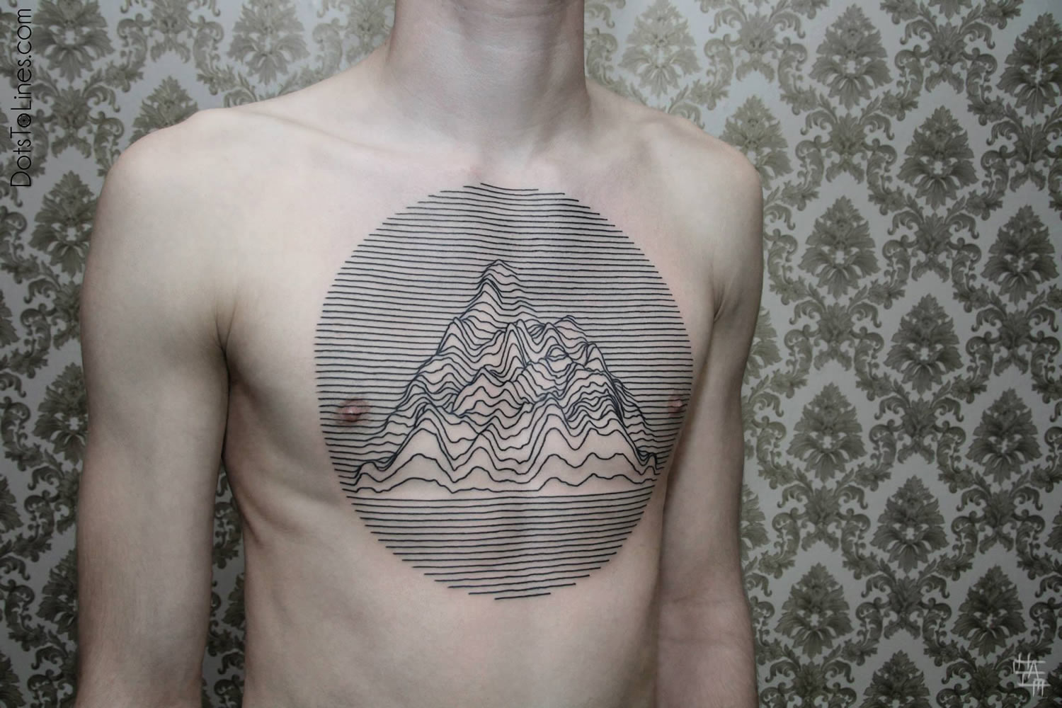 lines forming a mountain on chest, tattoo by chaim machlev