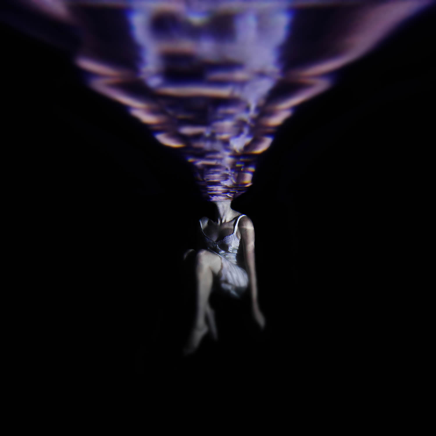 purple cloth and woman underwater, photo by jenna martin