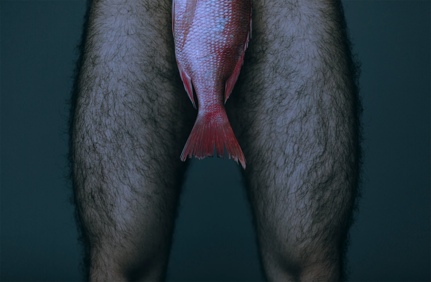 man with fish in front of body, photography by Daniel Molina