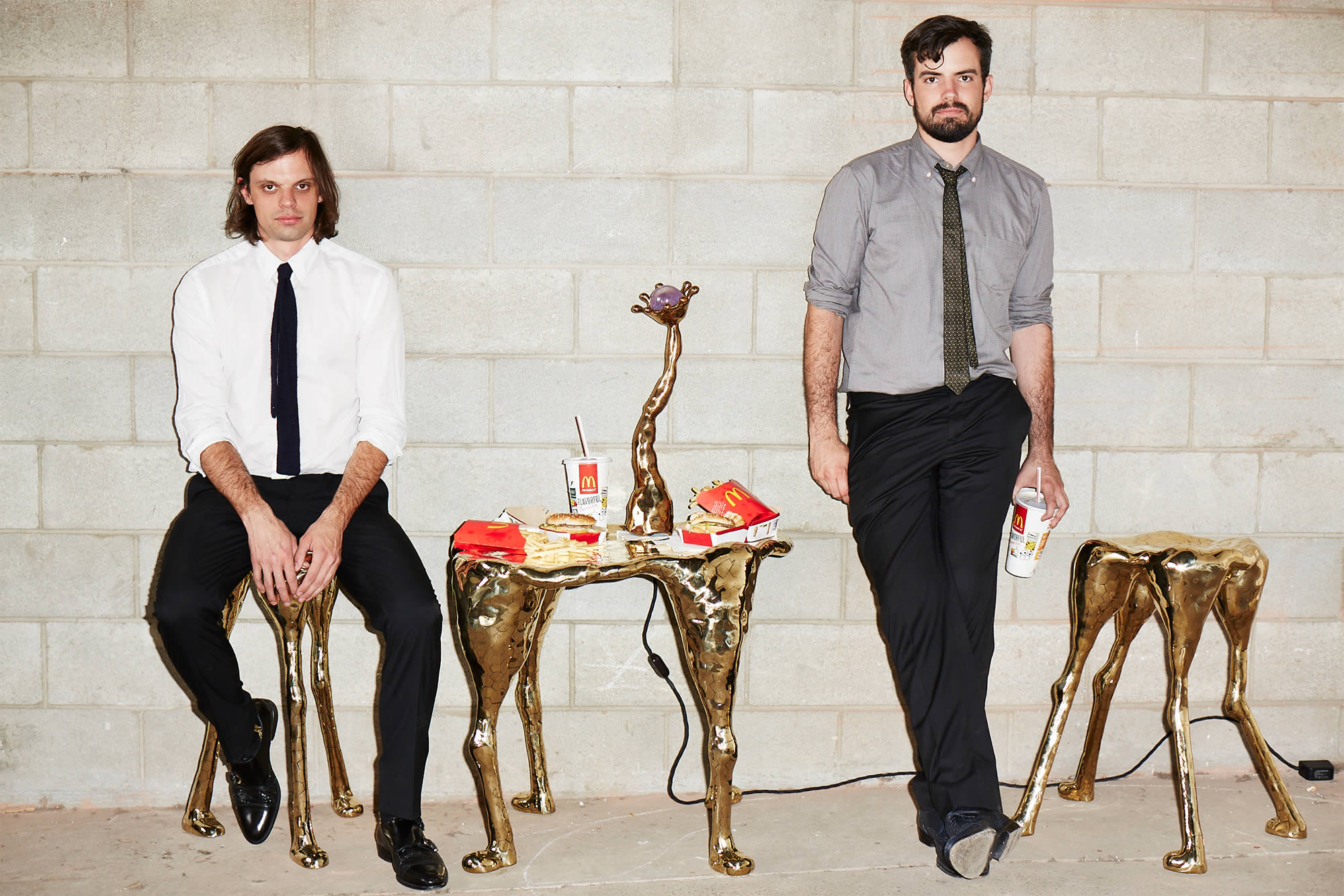 The Haas Brothers posing with furniture