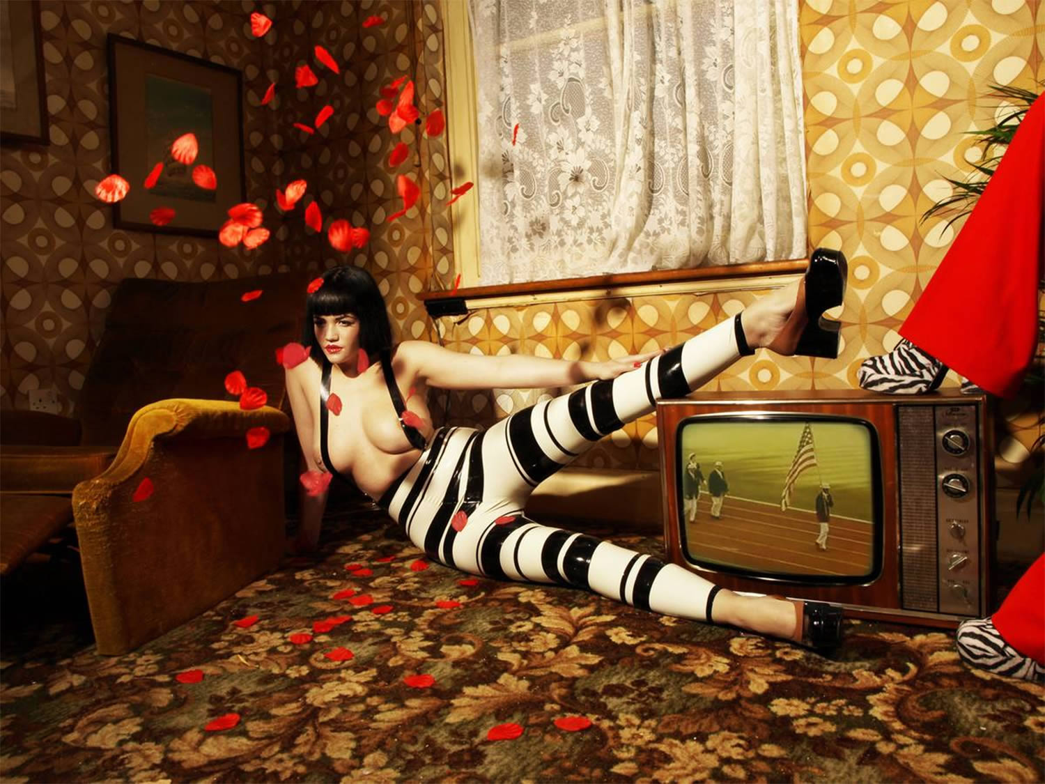 woman with striped paints in living room, by nadia lee cohen