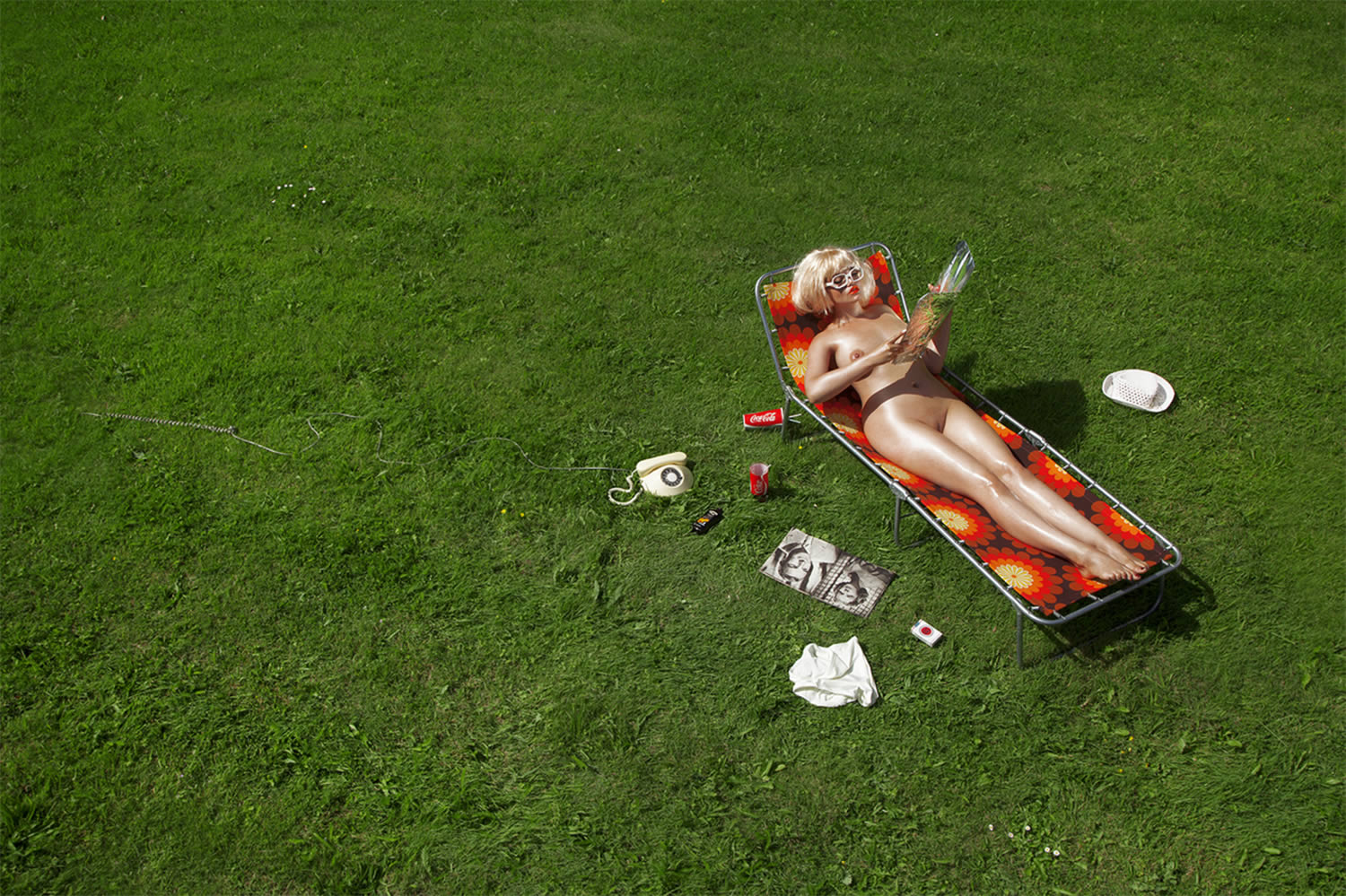 woman on sun bathing chair on grass lawn, by nadia lee cohen