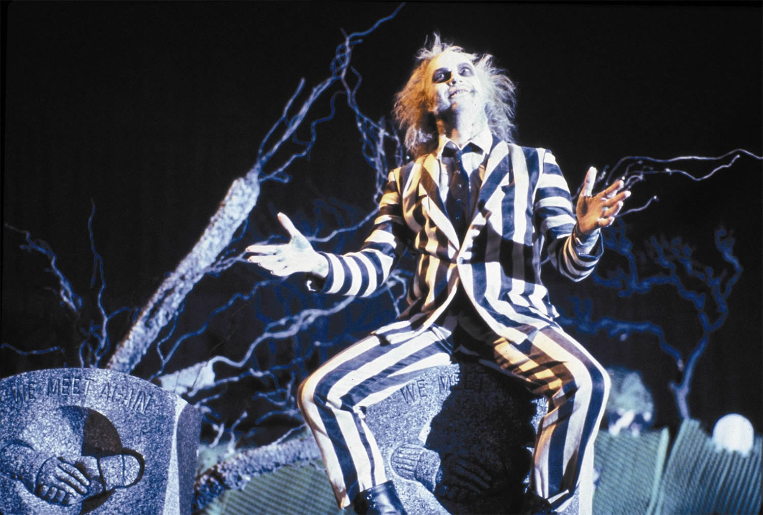 michael keaton in beetlejuice, wearing a stripe suit