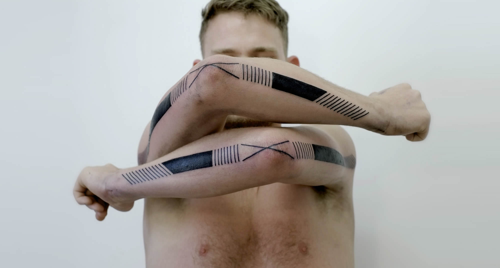 modern tribal tattoo on arms by victor j webster