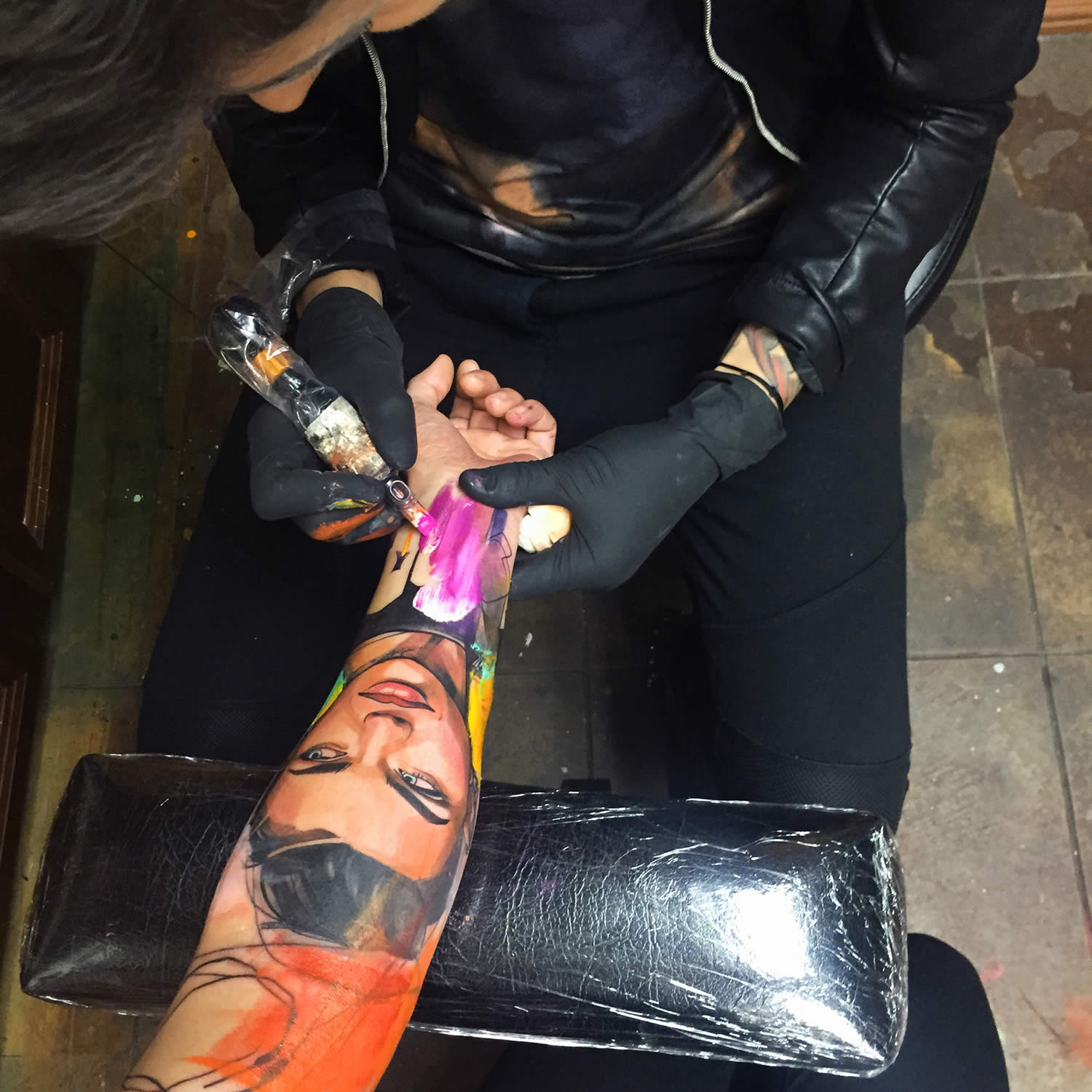 ivana tattooing a client's arm