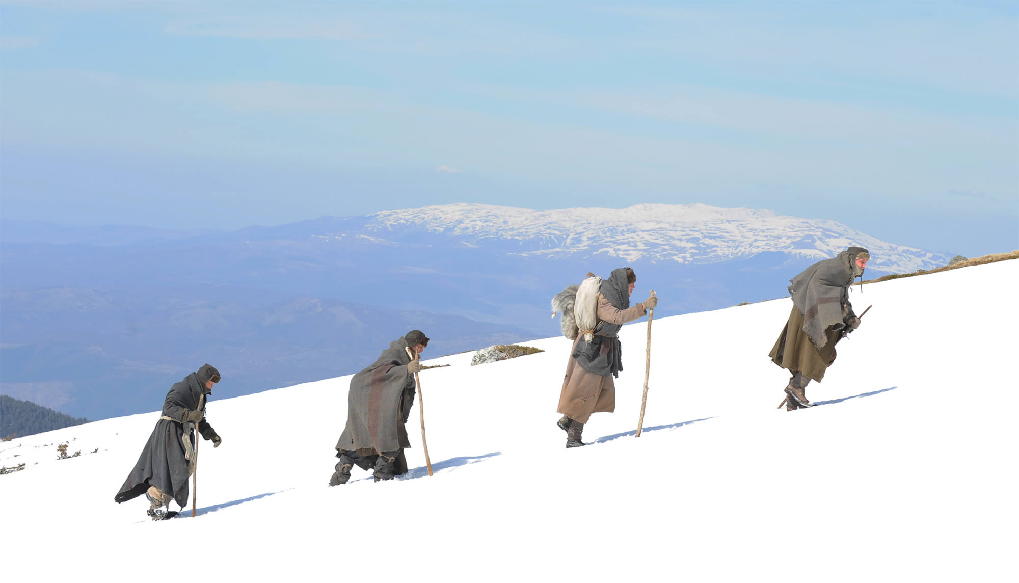The way back, men hiking up a snowy moutain