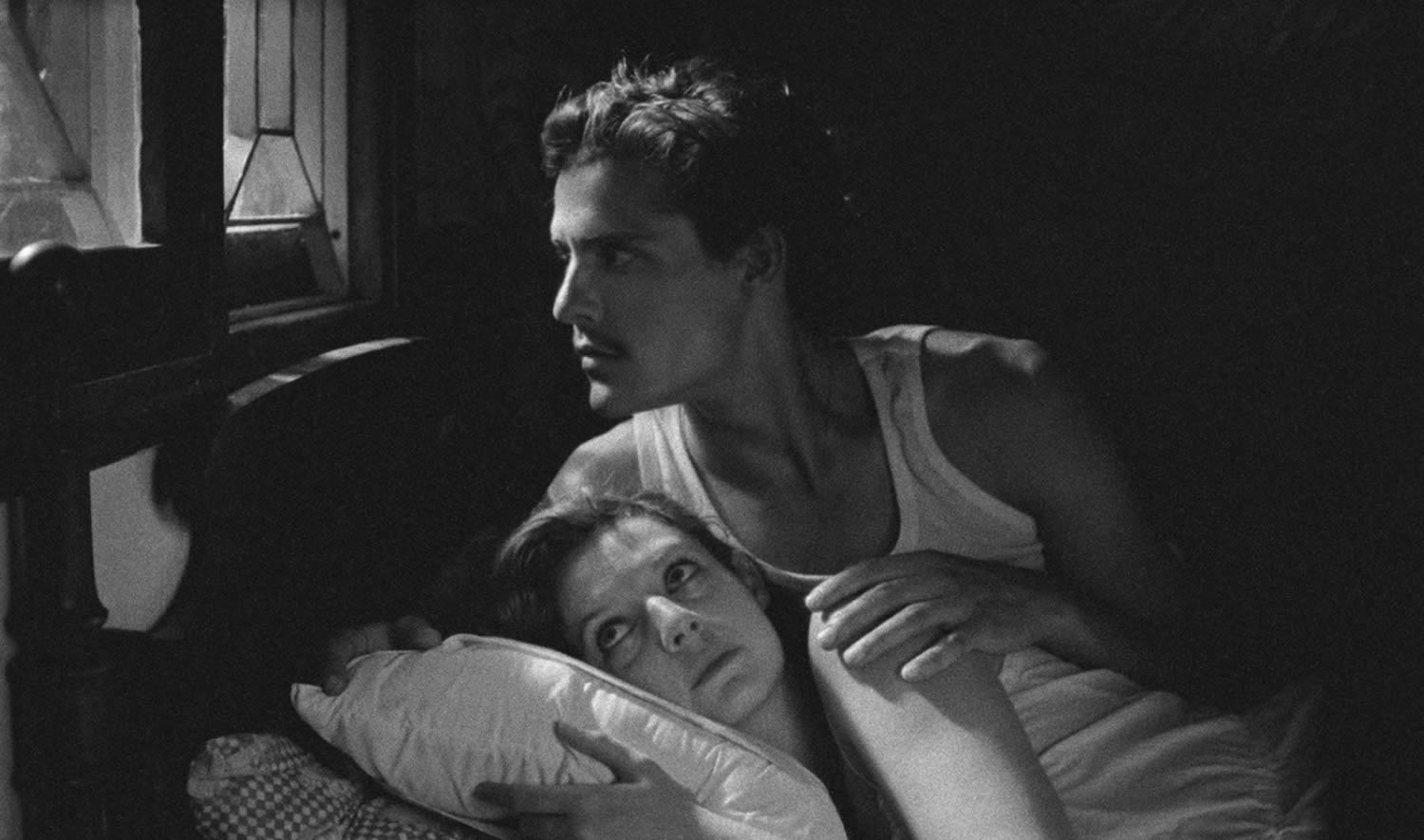 couple in bed, black and white scene in tabu