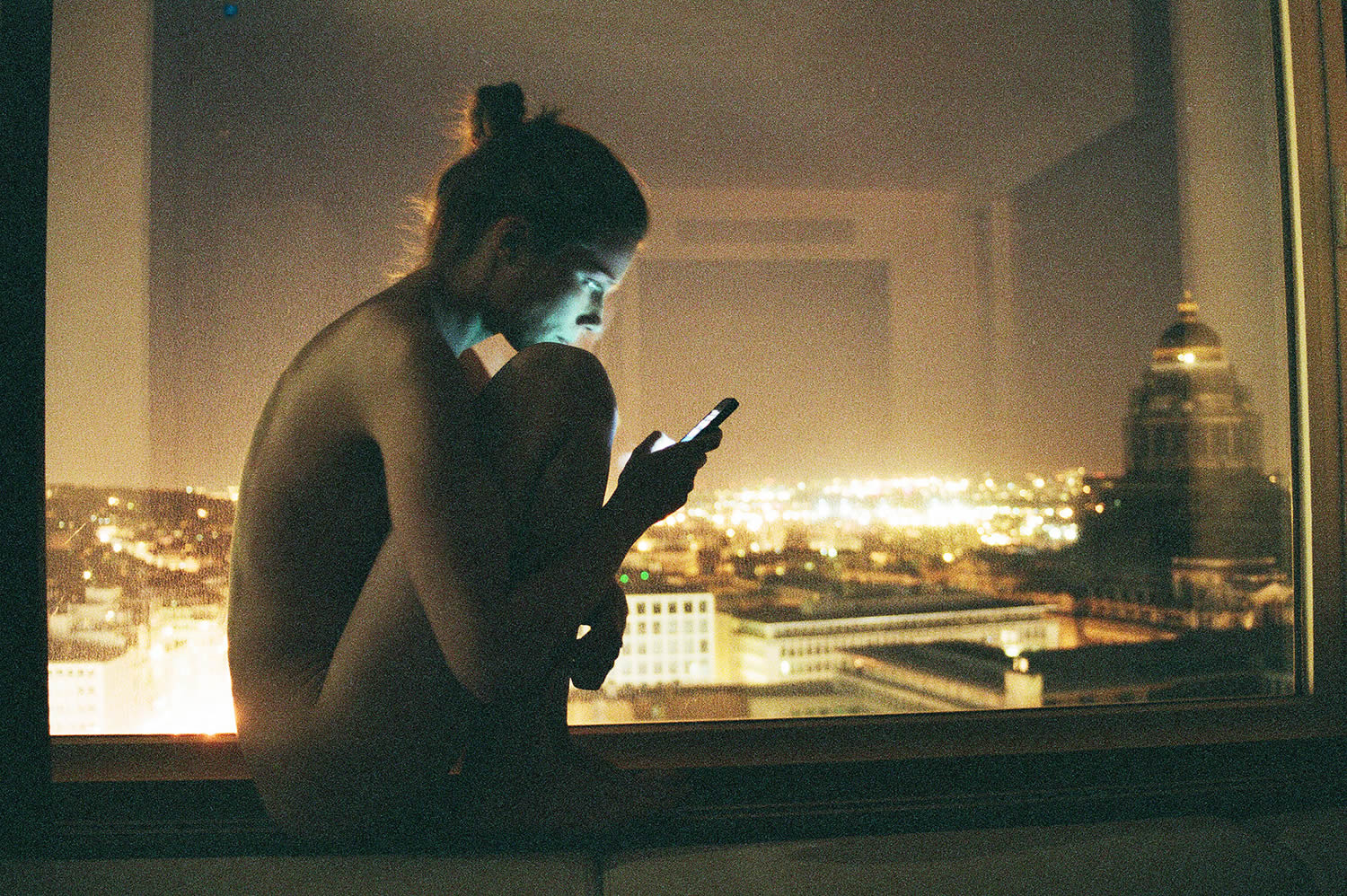 woman on windowsill, iphone