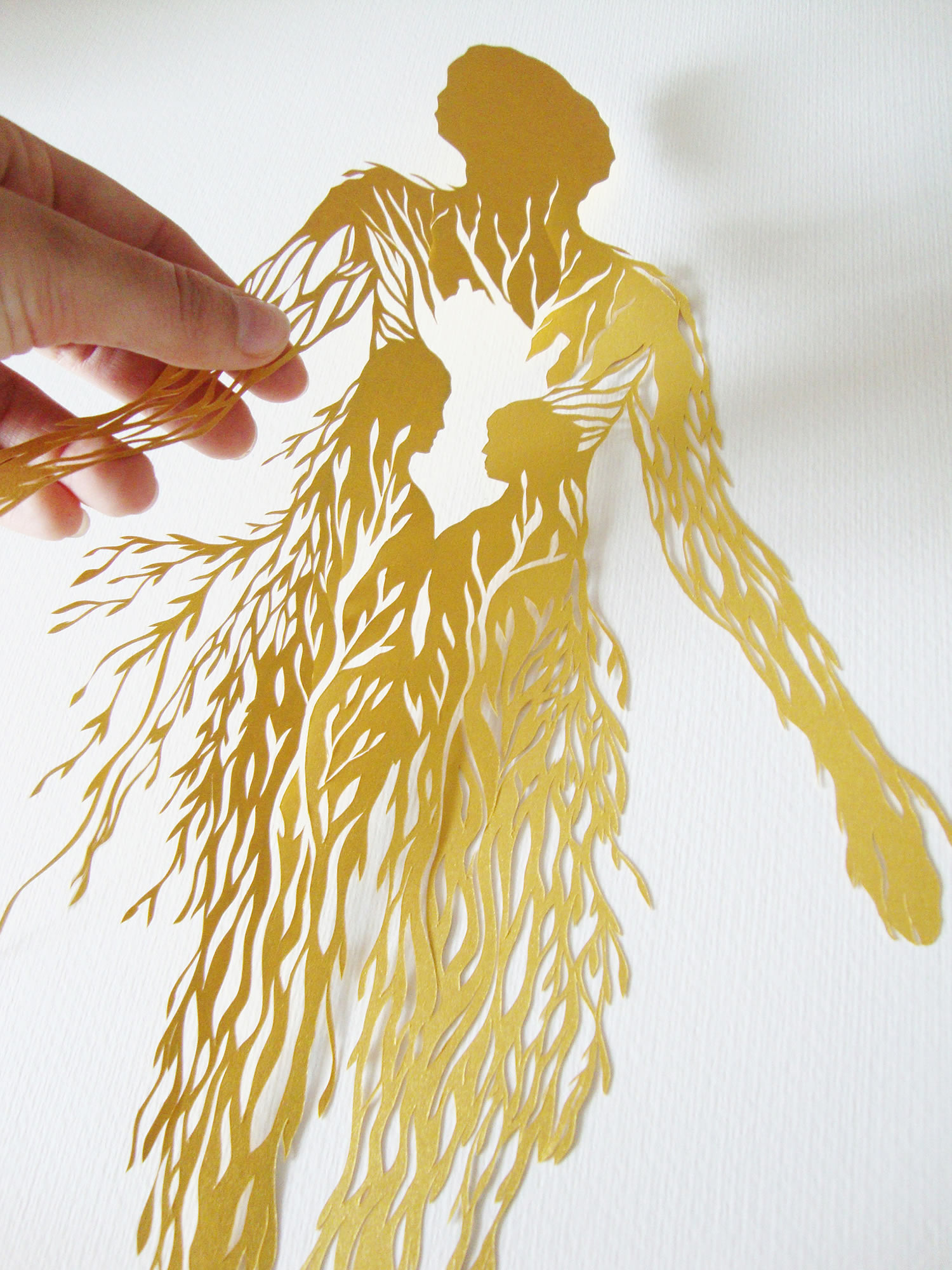 hand showcasing the intricacies of cut paper