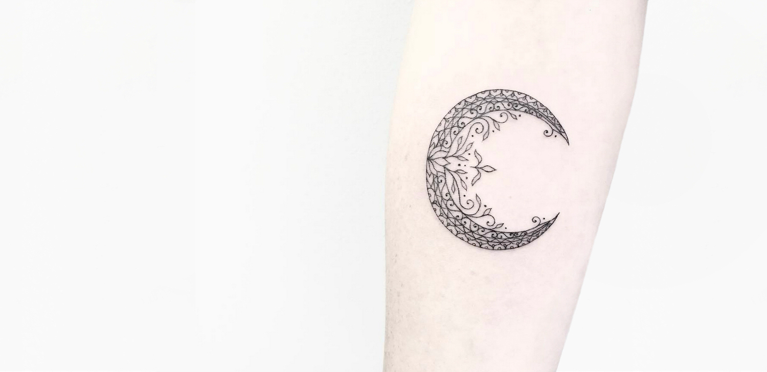 Crescent moon tattoo by Caitlin Thomas.