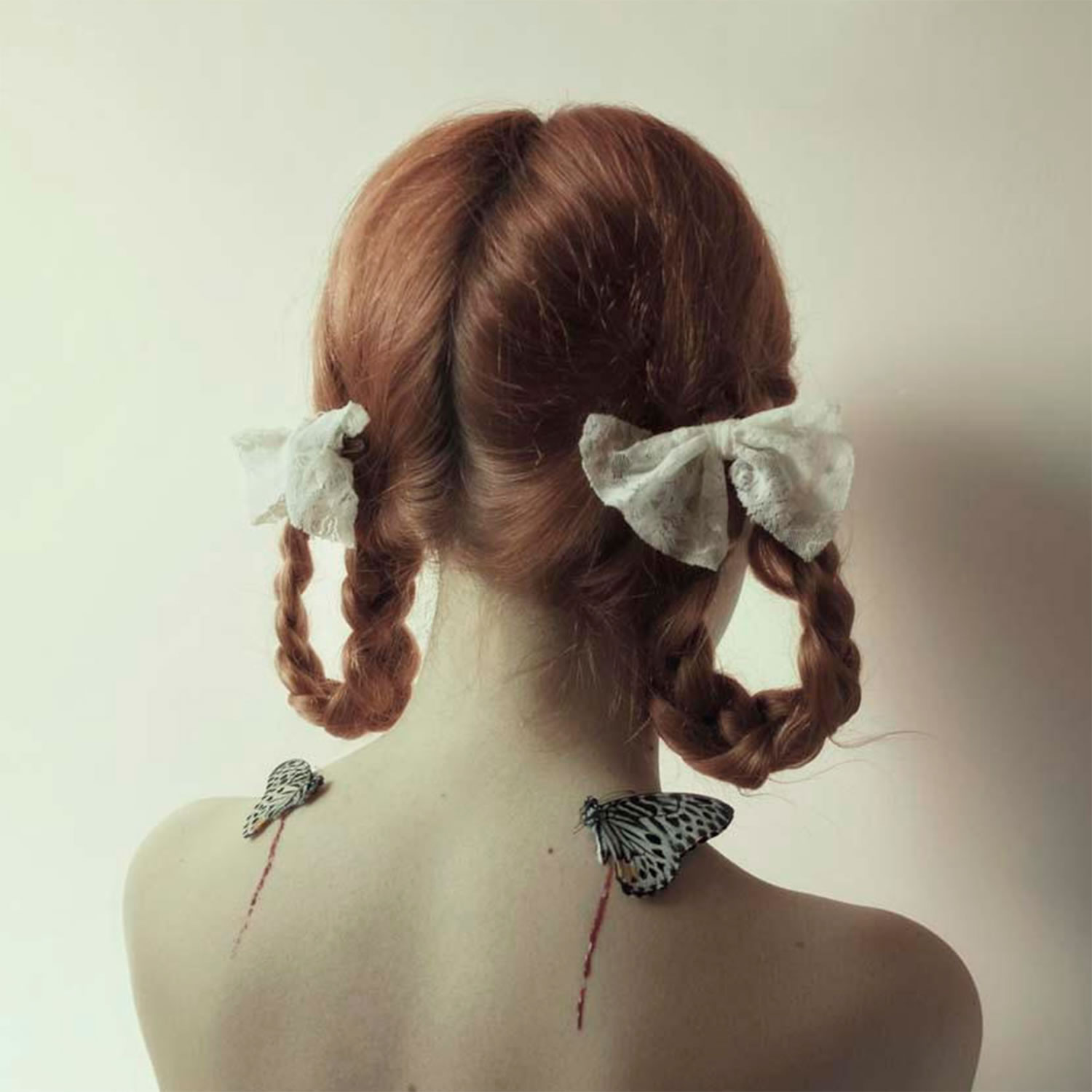 girl with bows on braided hair, butterflies on shoulders