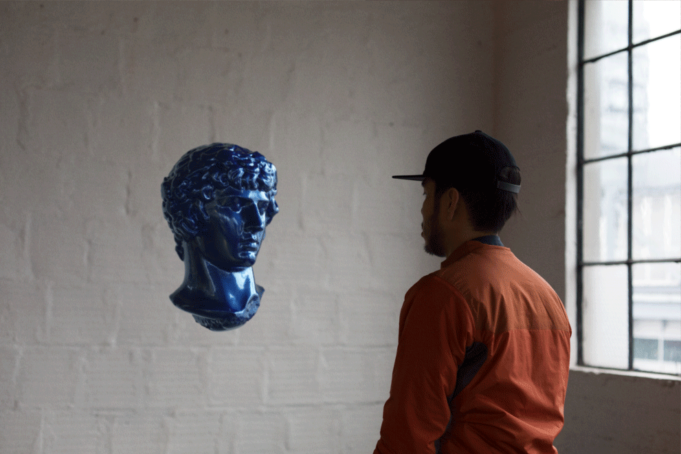 blue classical sculpture head, and guy looking at it, animated gif