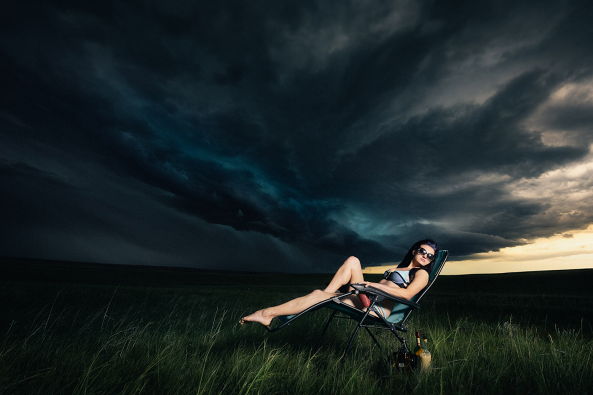 Benjamin Von Wong - woman lounging under storm clouds
