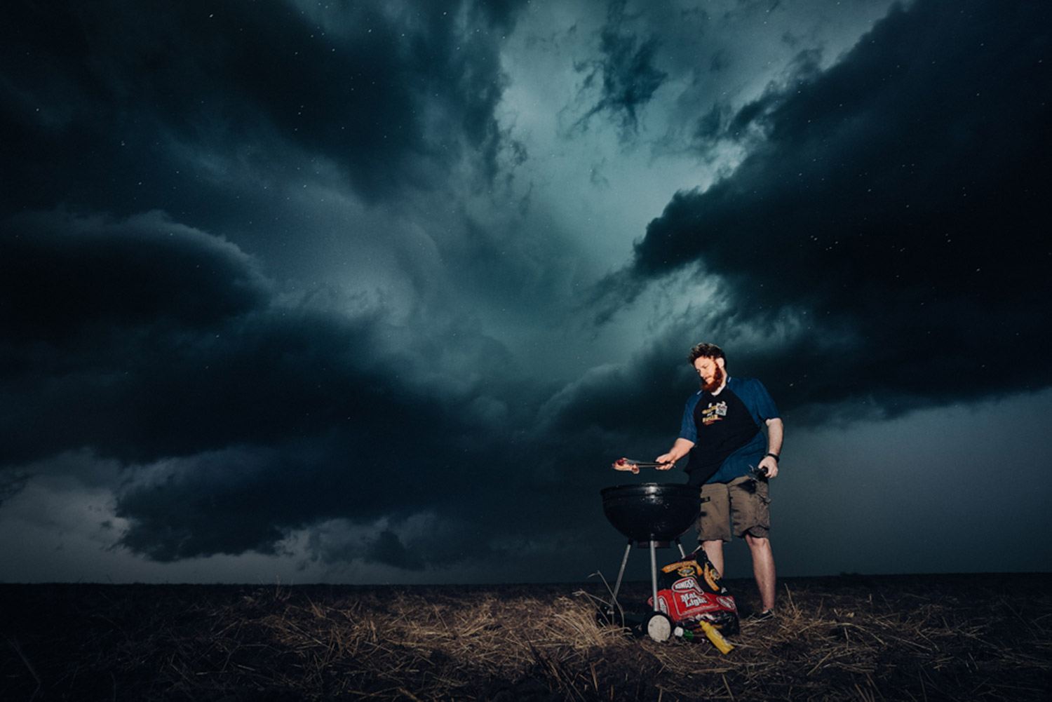 Benjamin Von Wong - man barbecuing in storm