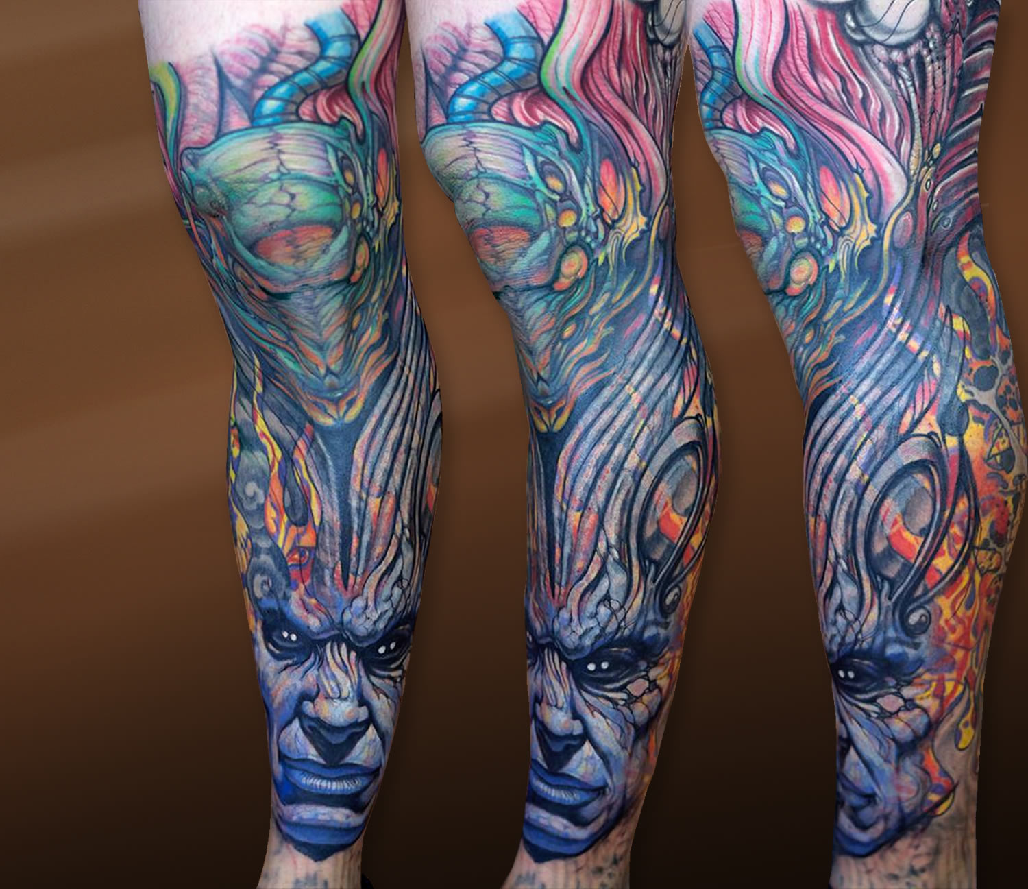 colorful surreal biomechanical tattoo on leg by paco dietz