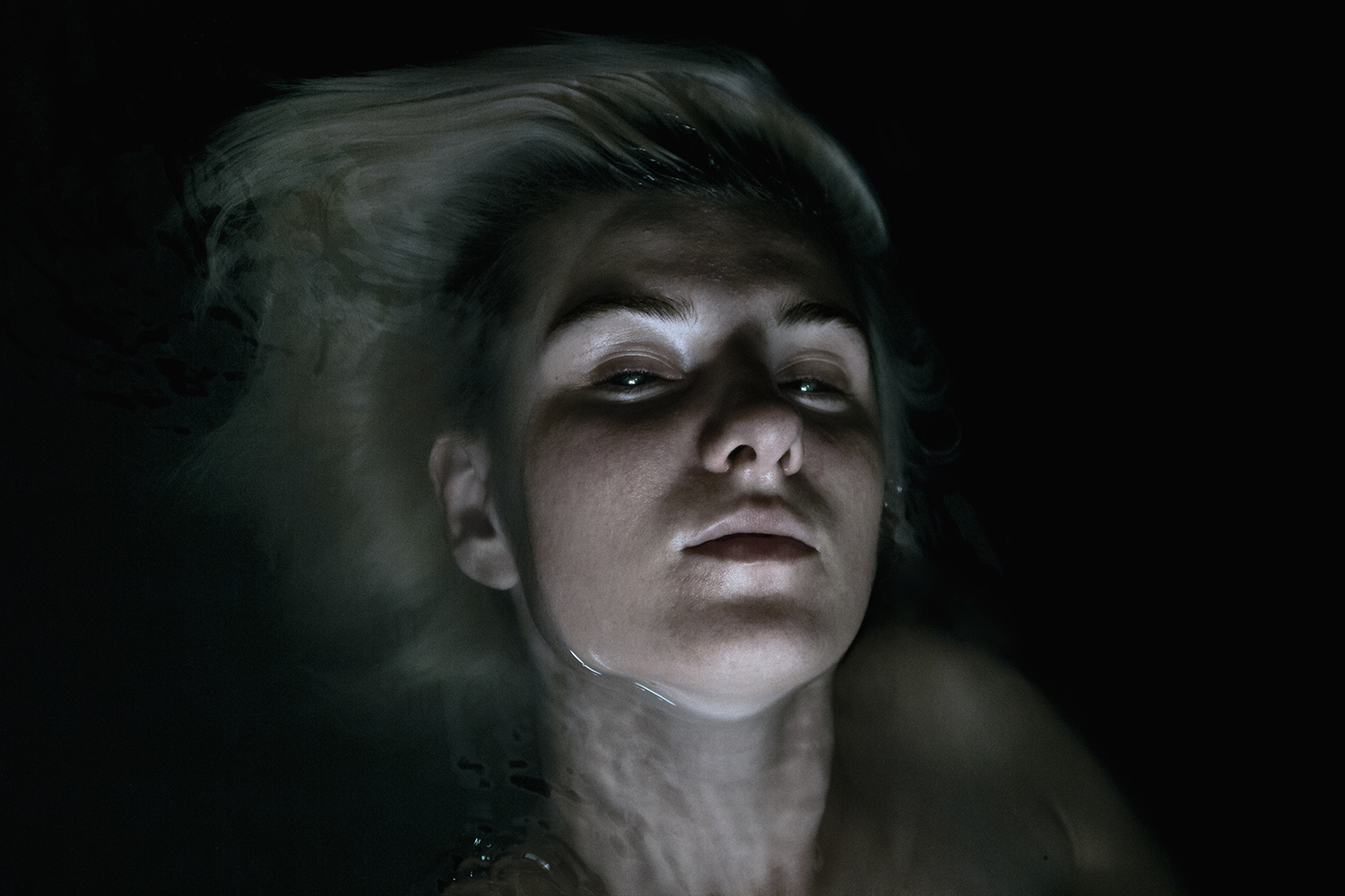 Elena Helfrecht - woman half-submerged in dark water