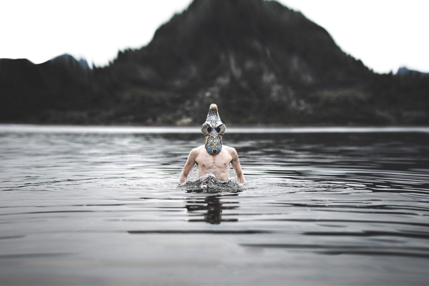 Leonard Condemine - man wearing mask standing in water