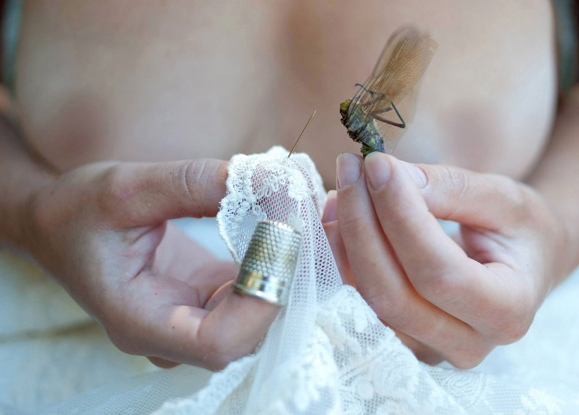 Ines Kozic - woman holding needle, thimble, and flying insect