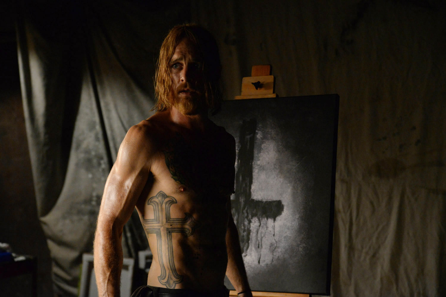 man with christ cross tattooed on body, in the devil's candy movie