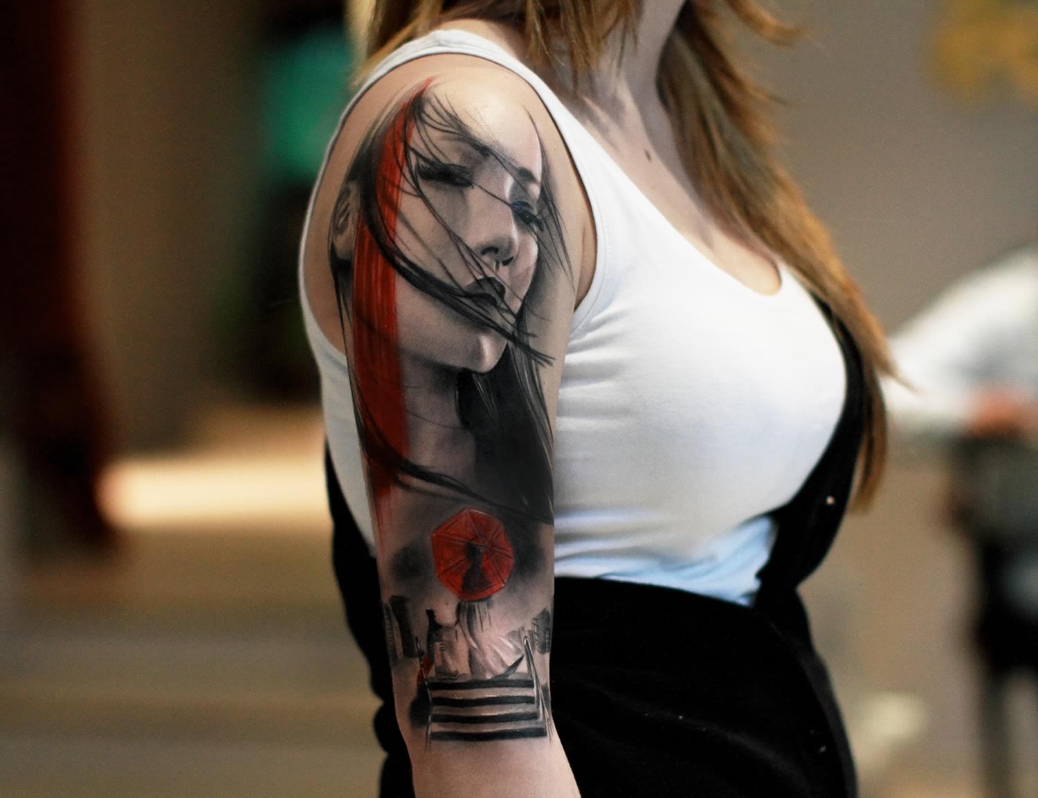 A tattoo artist applying ink on a girls thigh at the 2016 Italian News  Photo  Getty Images