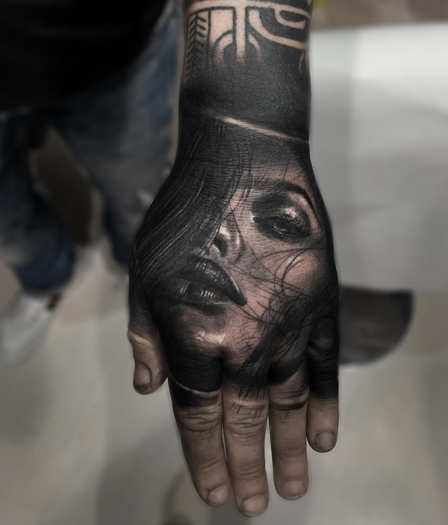 woman portrait tattooed on hand. hand tattoo