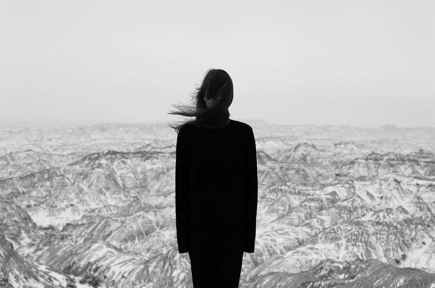 black and white photo, girl in front of canyon