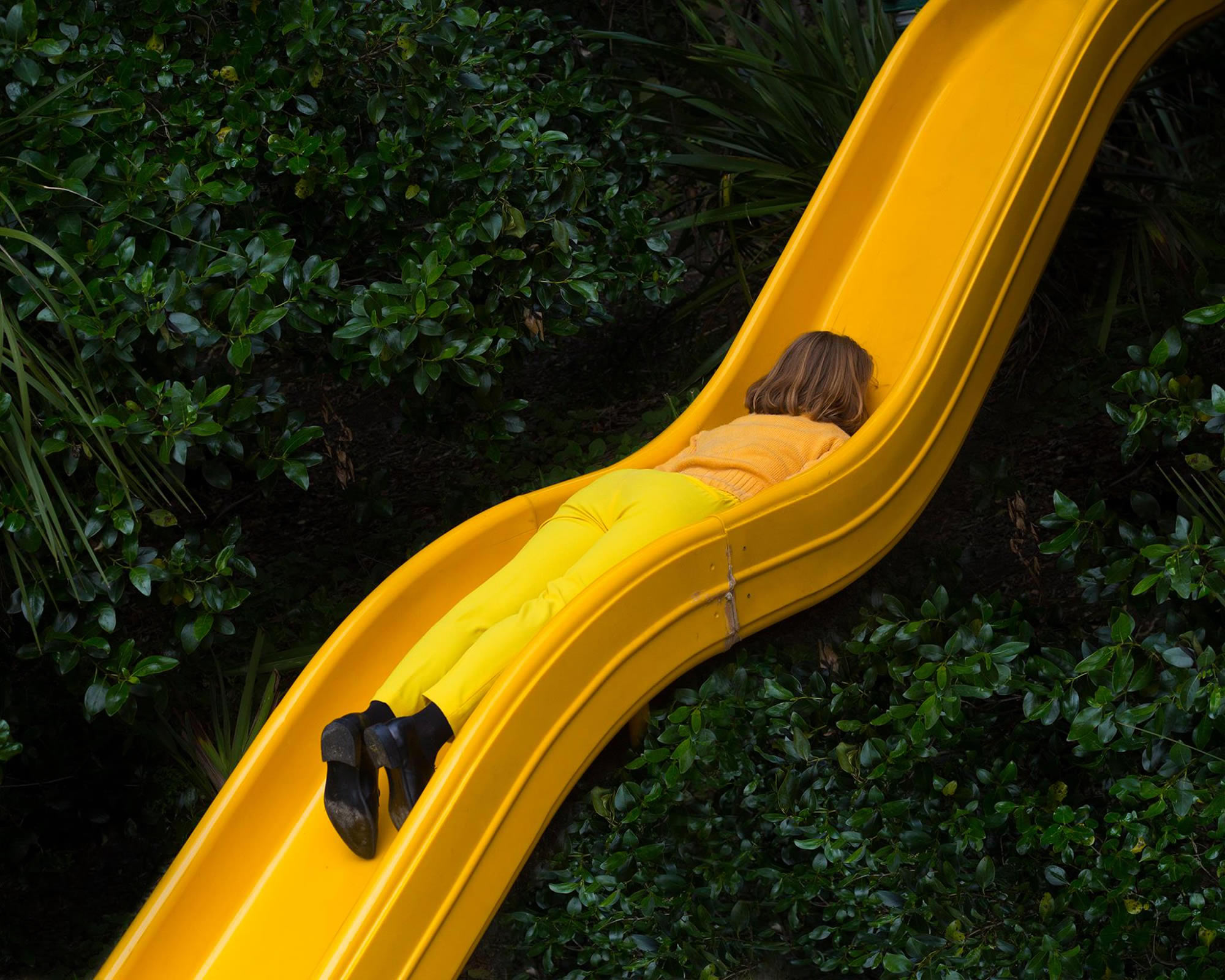 woman dressed in yellow on yellow water slide, photography