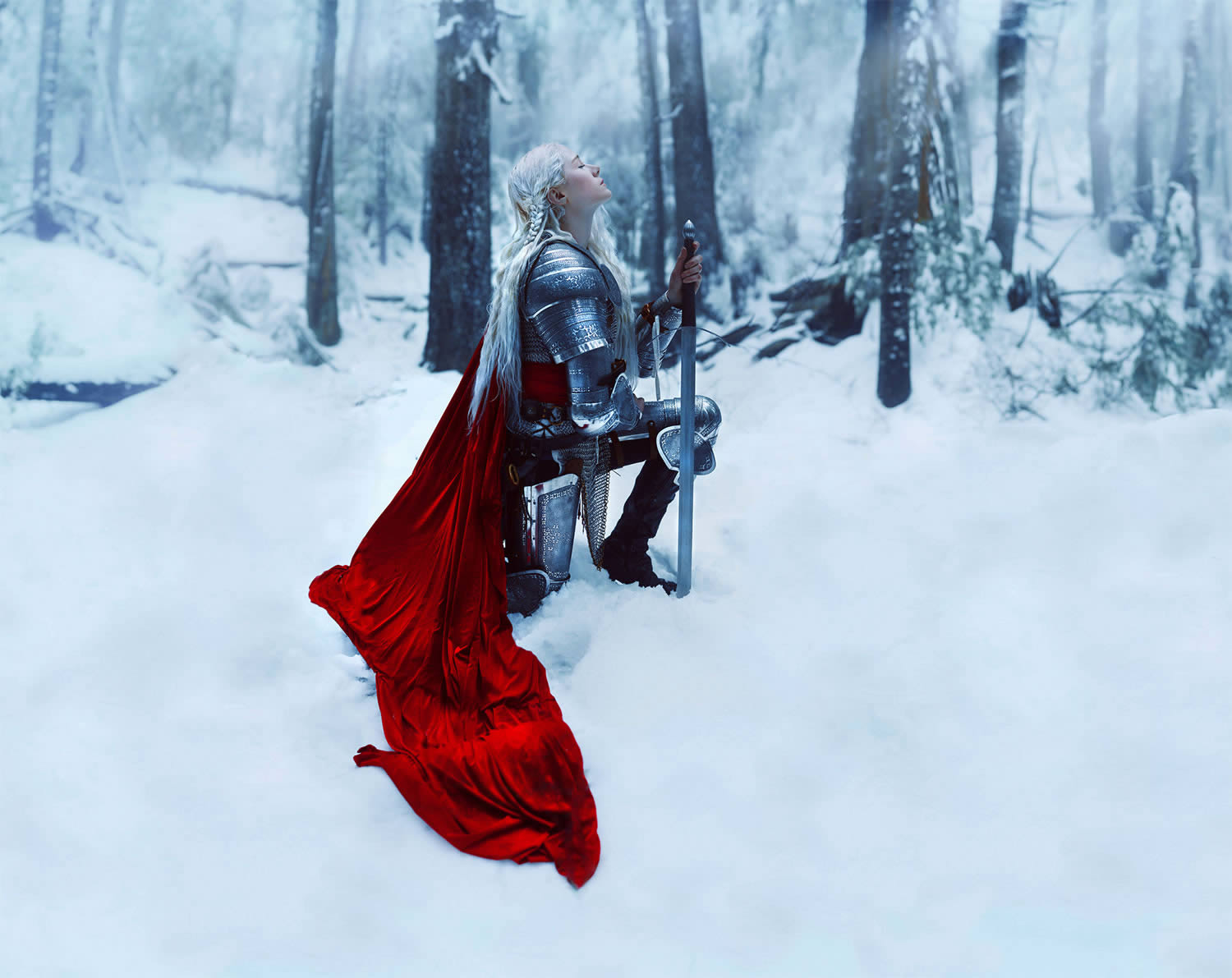knight with red cape, kneeling on snow