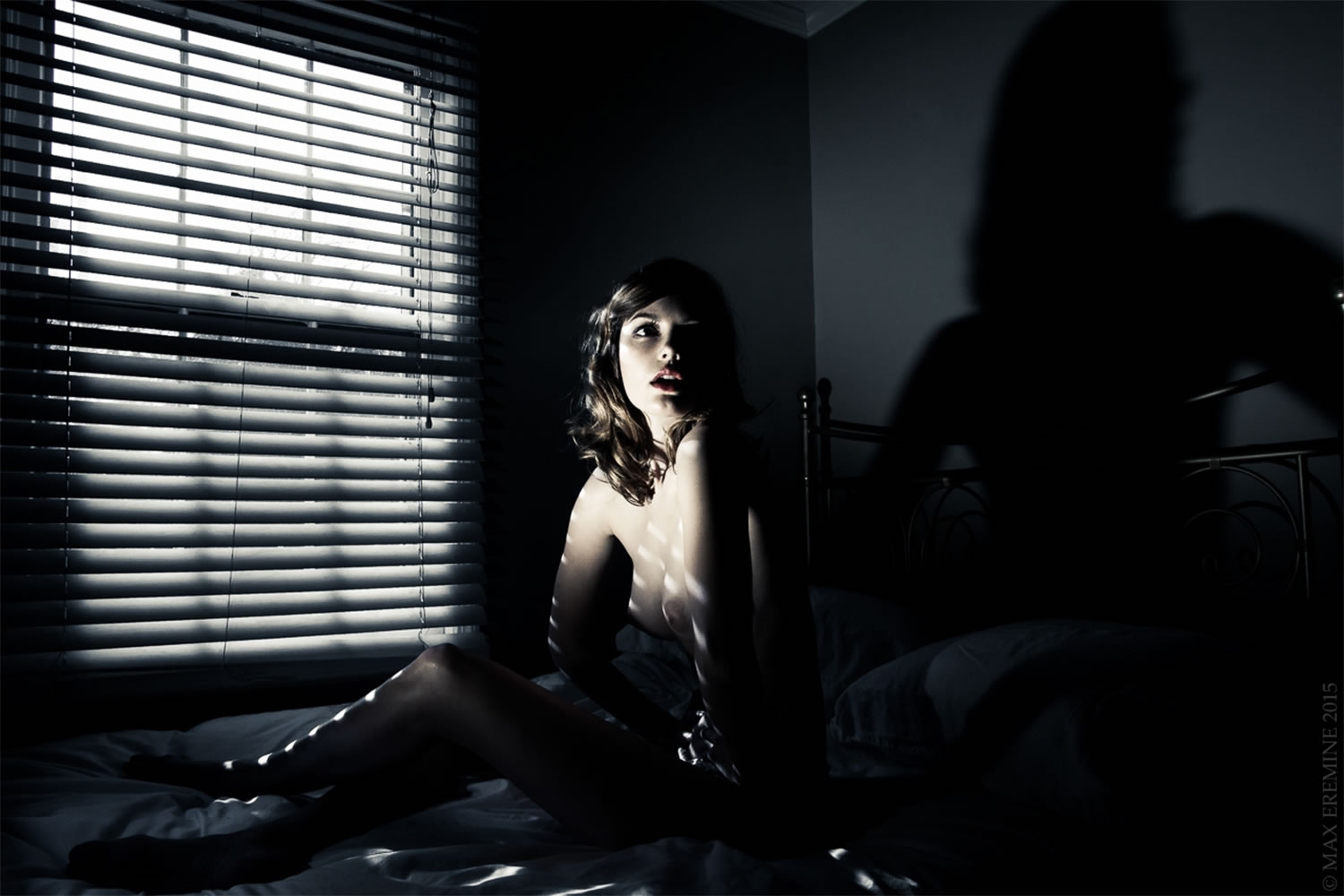 shadows from blinds, woman in dark room, photography by max eremine 