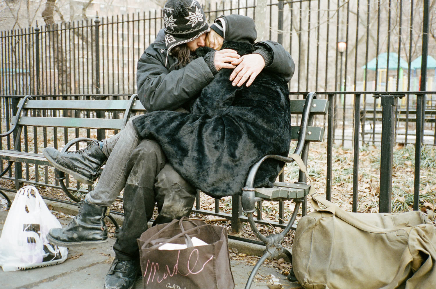 couple hugging in a street bench, heaven knows what