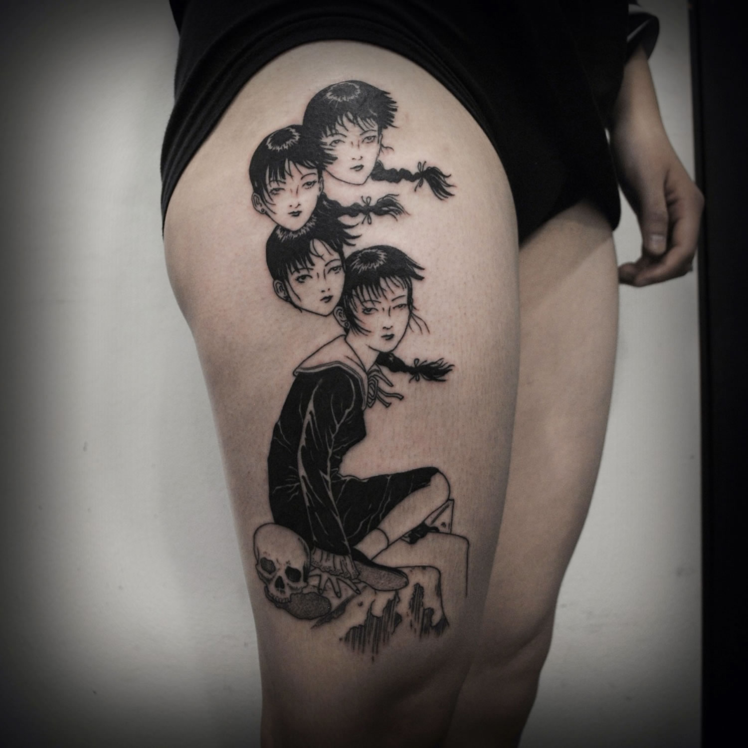 girl with various heads, tattoo on leg