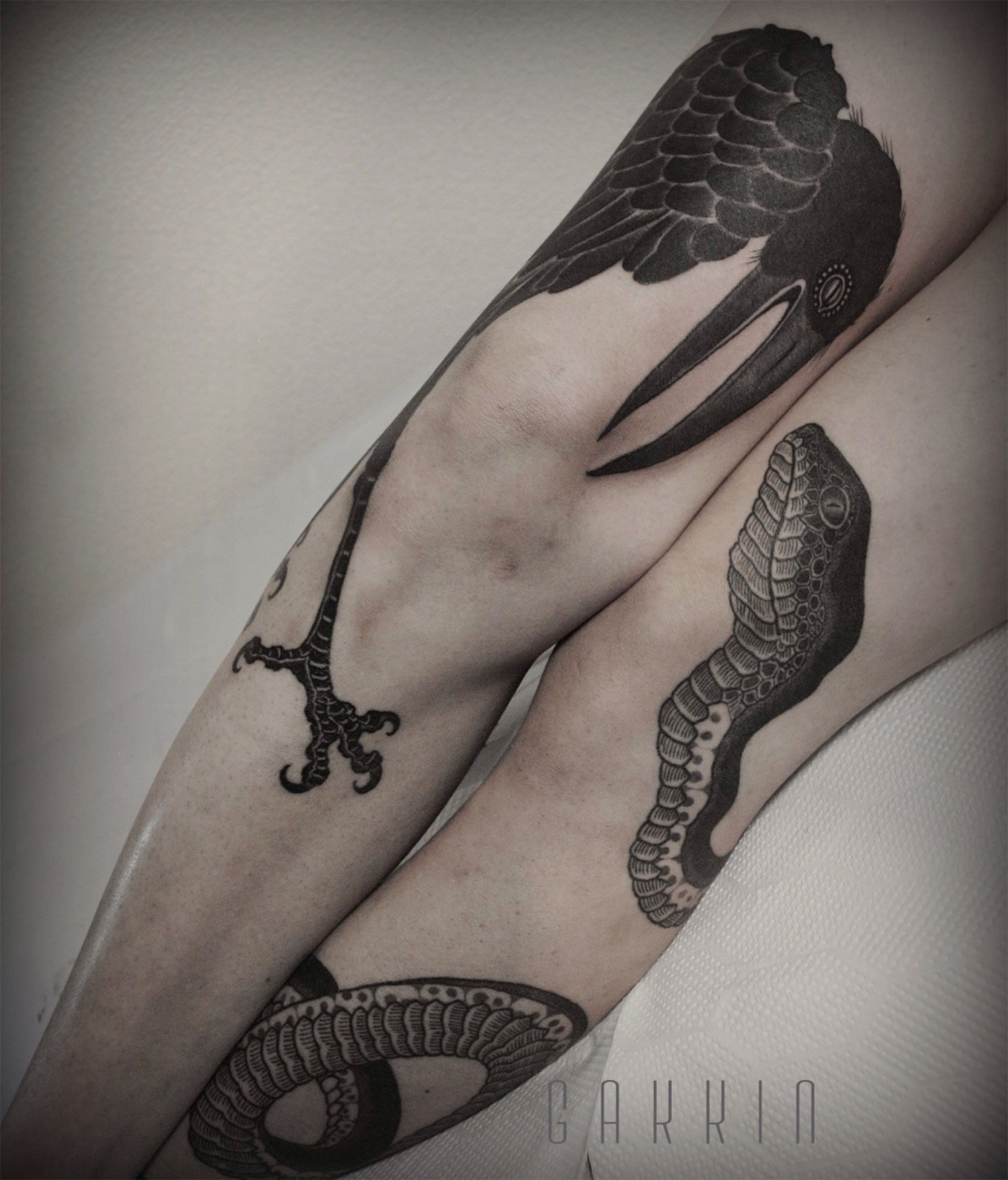 crow and snake tattoo on legs