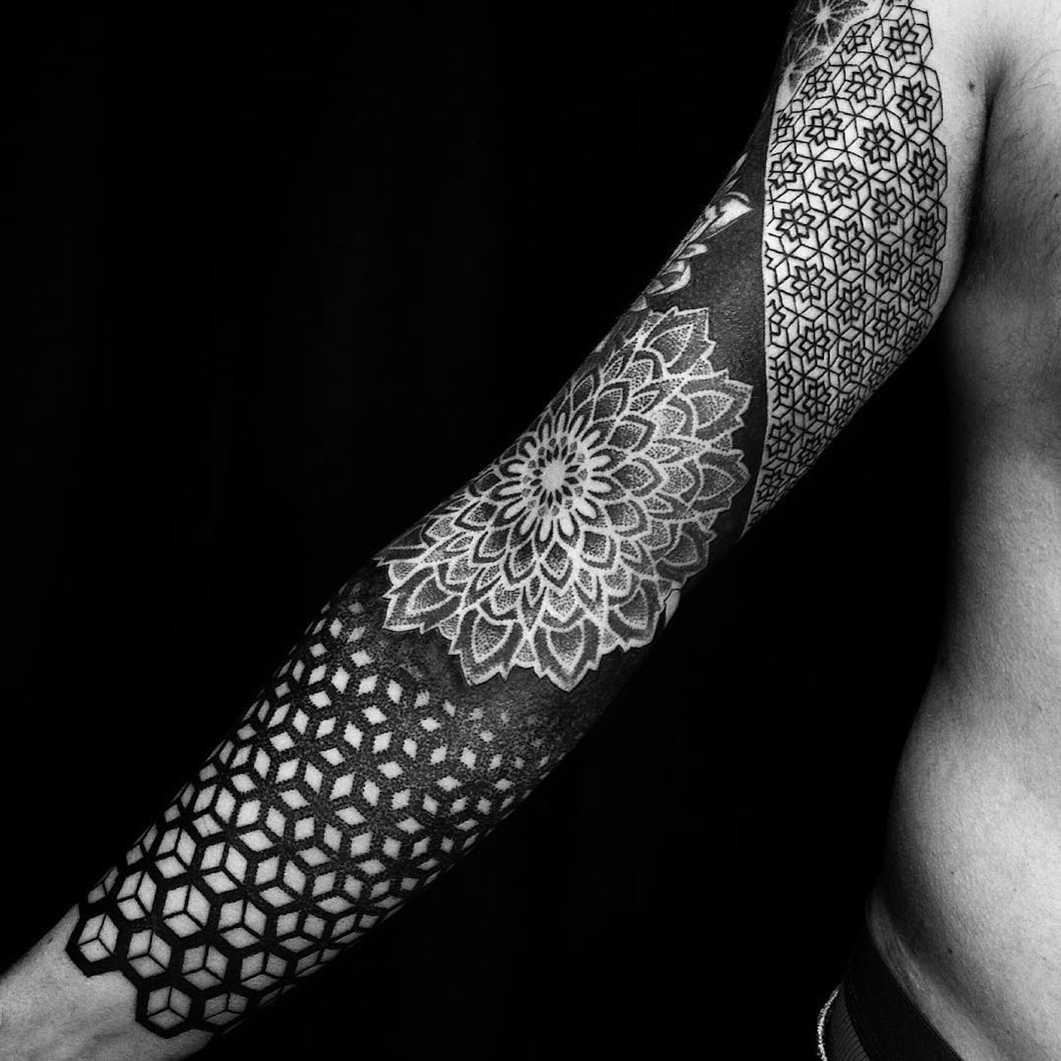 geometric tattoo down arm by Caco Menegaz